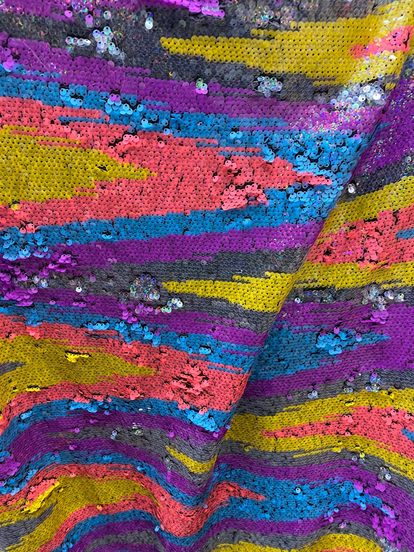 New chevron design multicolor rainbow sequins on stretch mesh 2-way 55/57” Sold by the YD. Ships worldwide from Los Angeles California USA.