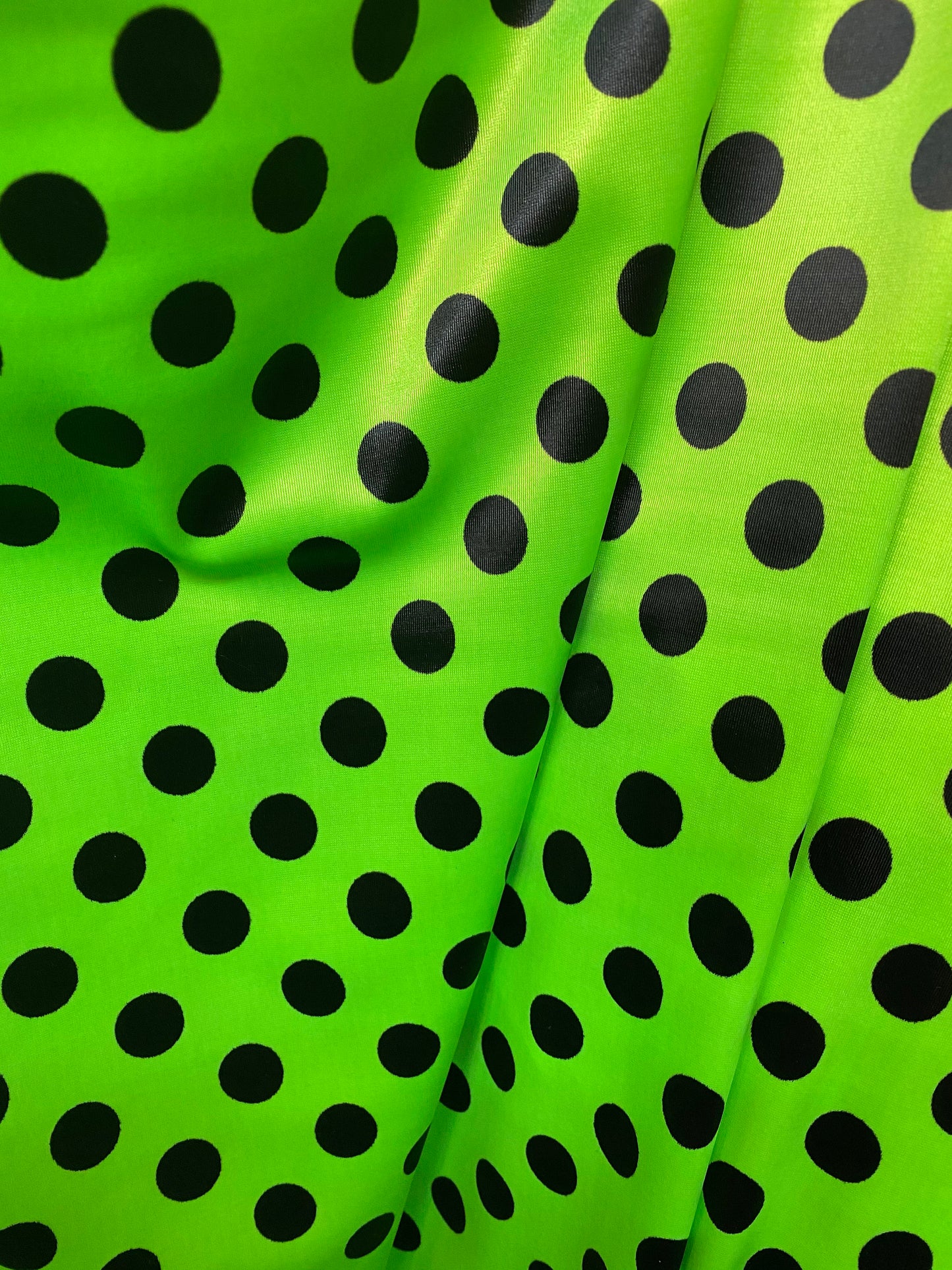 New polka dots design neon lime green with black dots nylon spandex 4-way stretch 58/60” Sold by the YD. Ships worldwide from Los Angeles CA