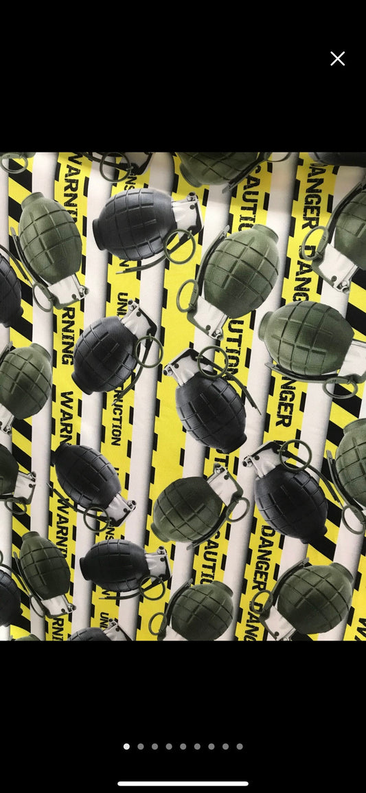 New Grenades caution danger print on nylon Spandex 4-way 58/60” Sold by the yard.  Print just as shown in the pictures. Ships worldwide