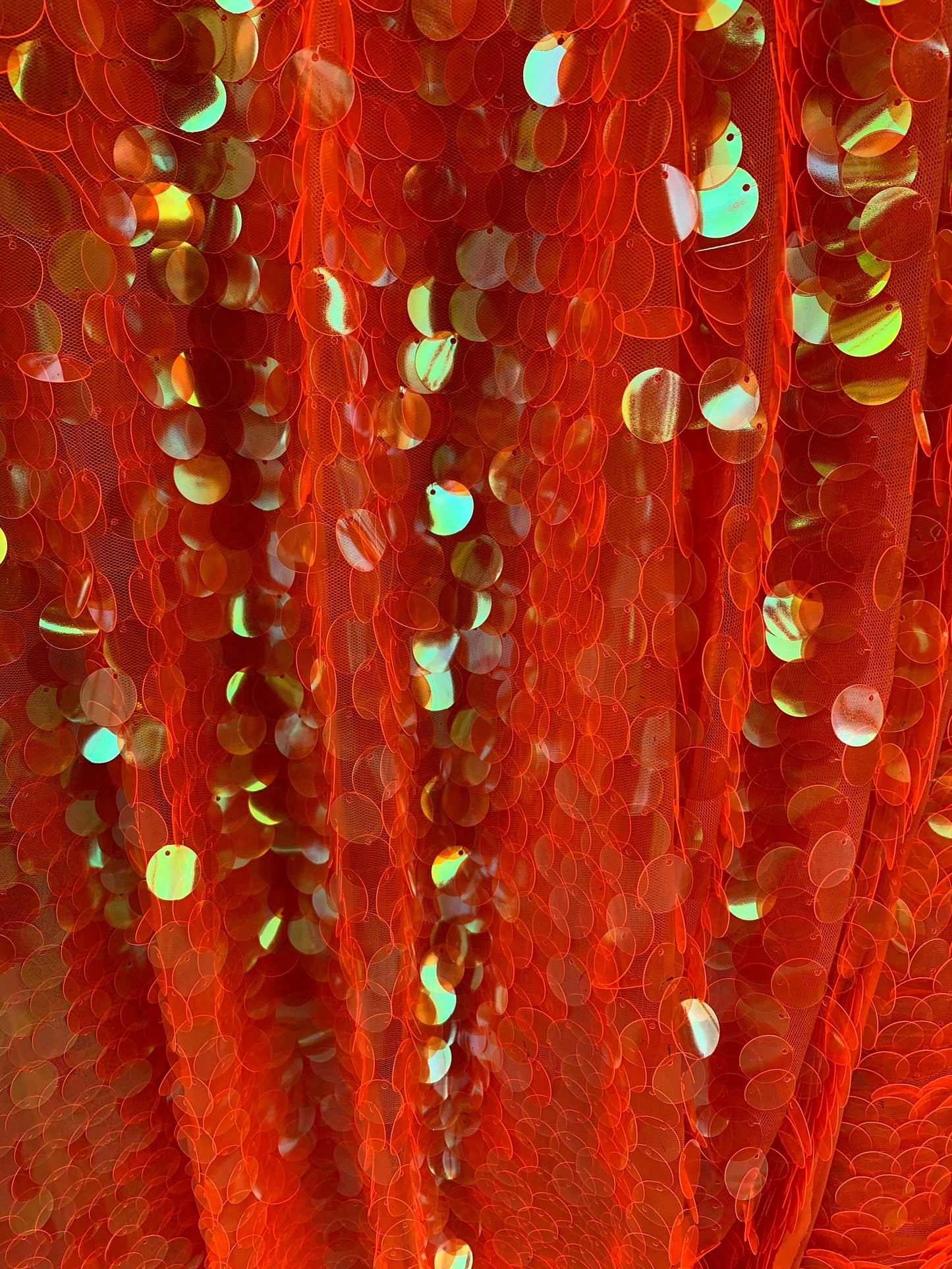 New Neon orange paillette sequins Iridescent orange 20mm size round sequins on stretch mesh 2-way 58/60” Sold by the YD. Ships worldwide.