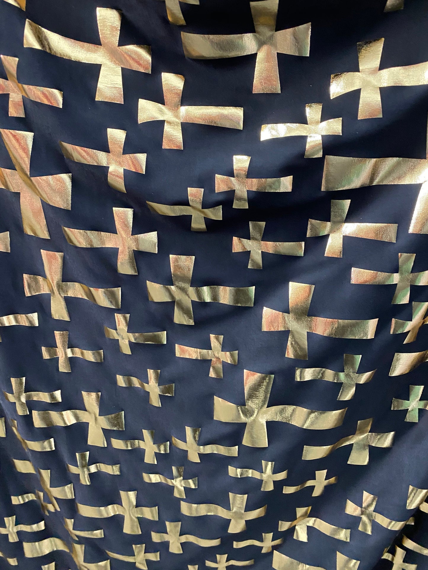 New metallic poly spandex cross design black/gold 2-way stretch 58/60” Sold by the YD. Ships worldwide from Los Angeles California USA.