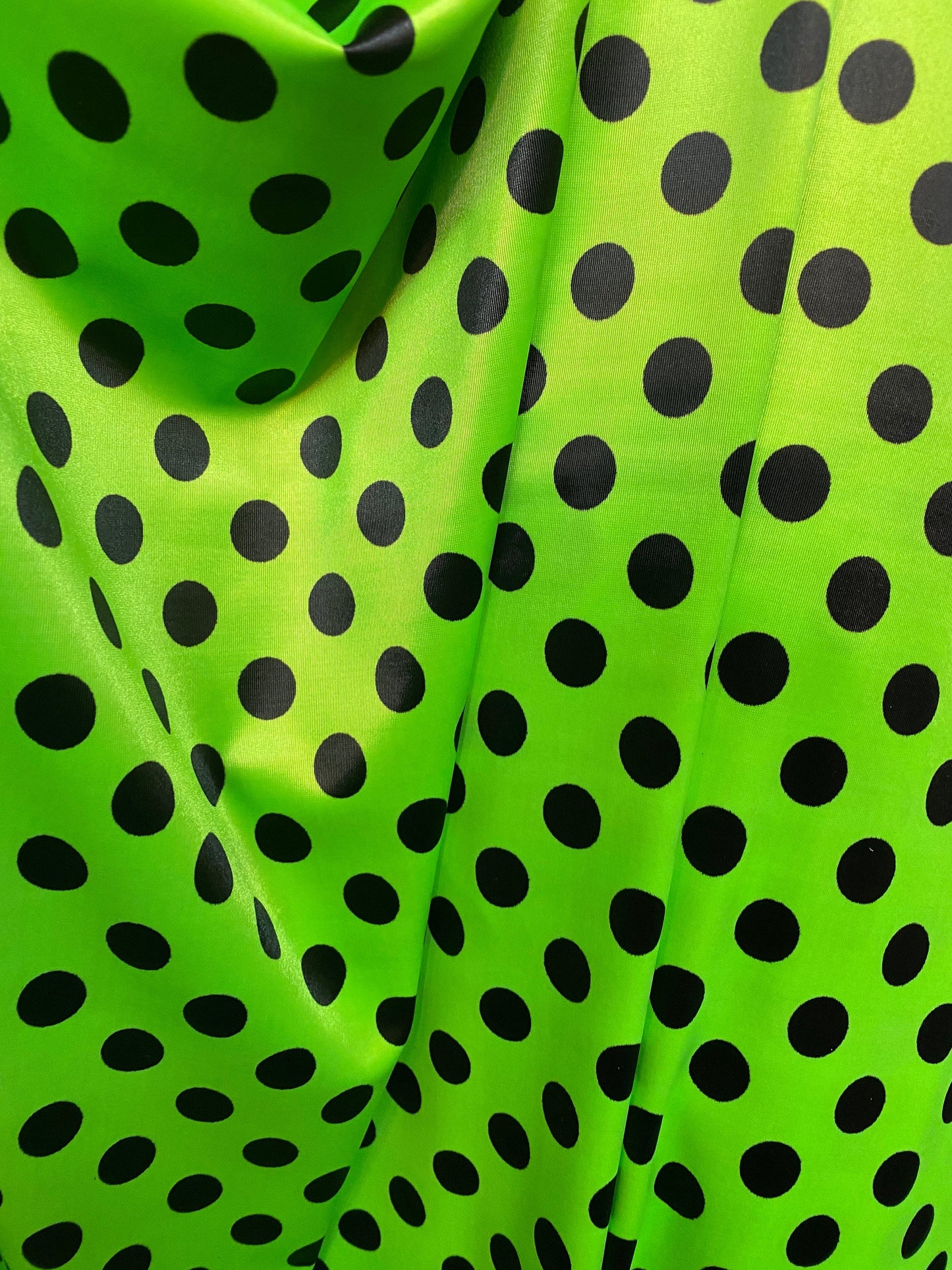 New polka dots design neon lime green with black dots nylon spandex 4-way stretch 58/60” Sold by the YD. Ships worldwide from Los Angeles CA