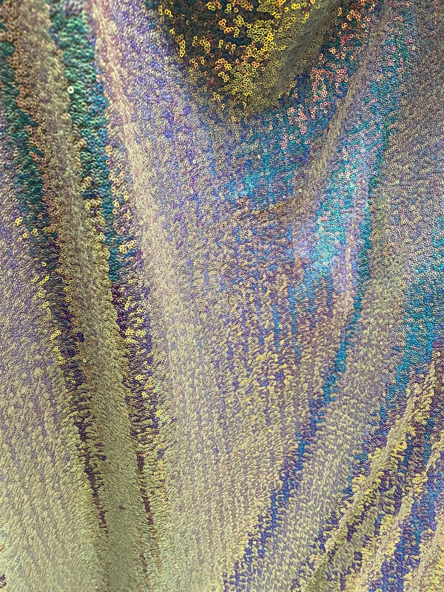 New cosmic sequins Iridescent white unicorn on stretch mesh 4-way 58/60” Sold by the YD. Ships worldwide from Los Angeles California USA.