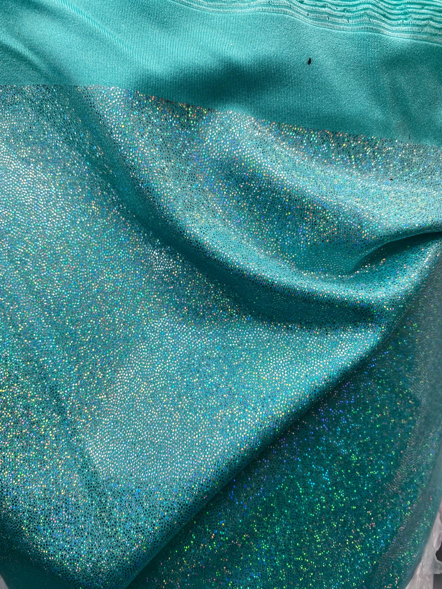 Sparkle hologram metallic nylon spandex 4way stretch 58/60” Sold by the YD. Ships worldwide from Los Angeles California USA.