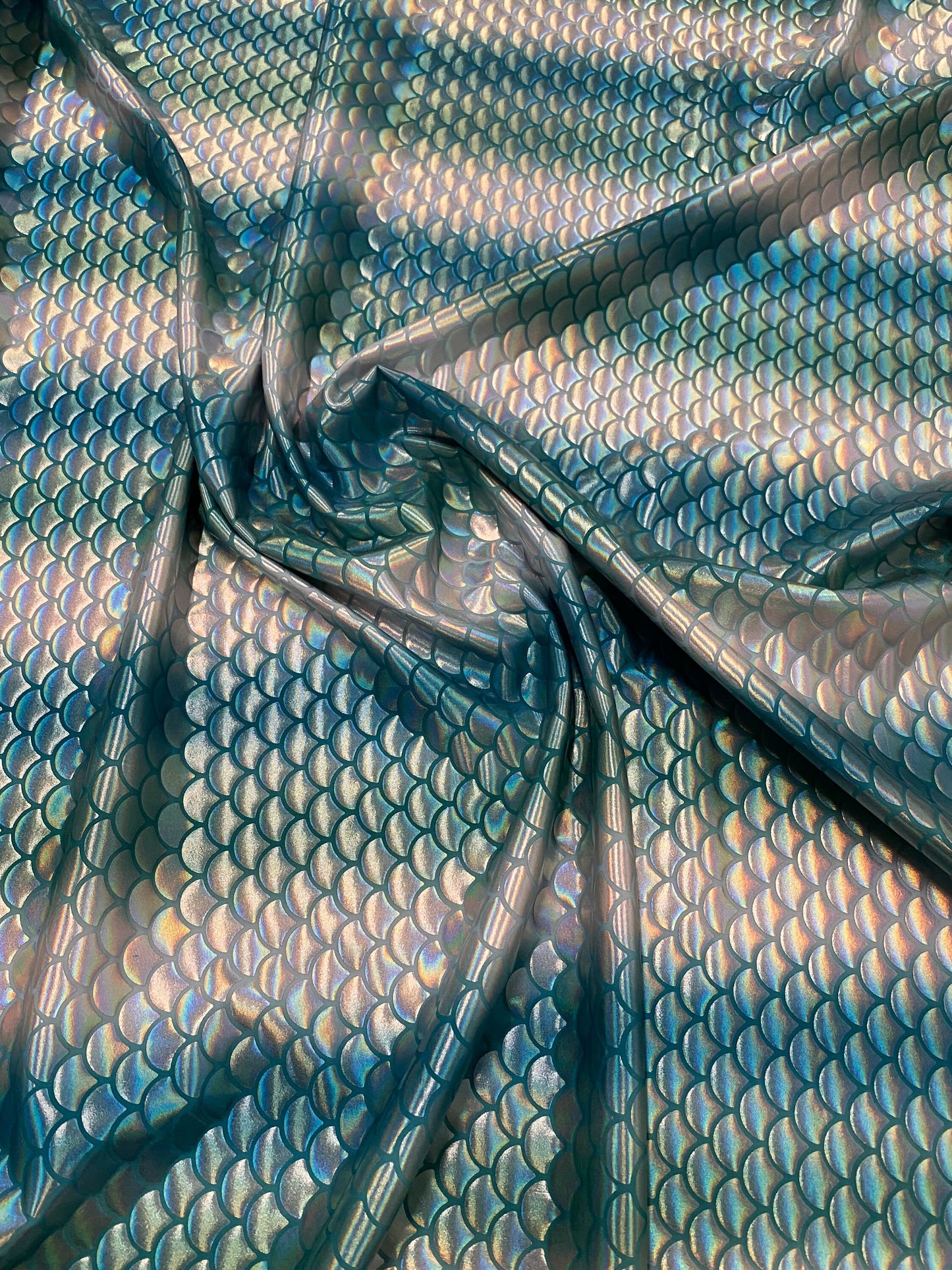 New Rainbow mermaid design Aqua/Teal iridescent metallic nylon spandex 4-way stretch 58/60” Sold by the YD. Ships worldwide from L.A CA.