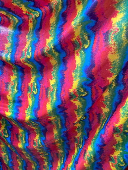 New Lava design rainbow color print nylon spandex with clear foggy foil all over 4-way stretch 58/60” Sold by the YD.