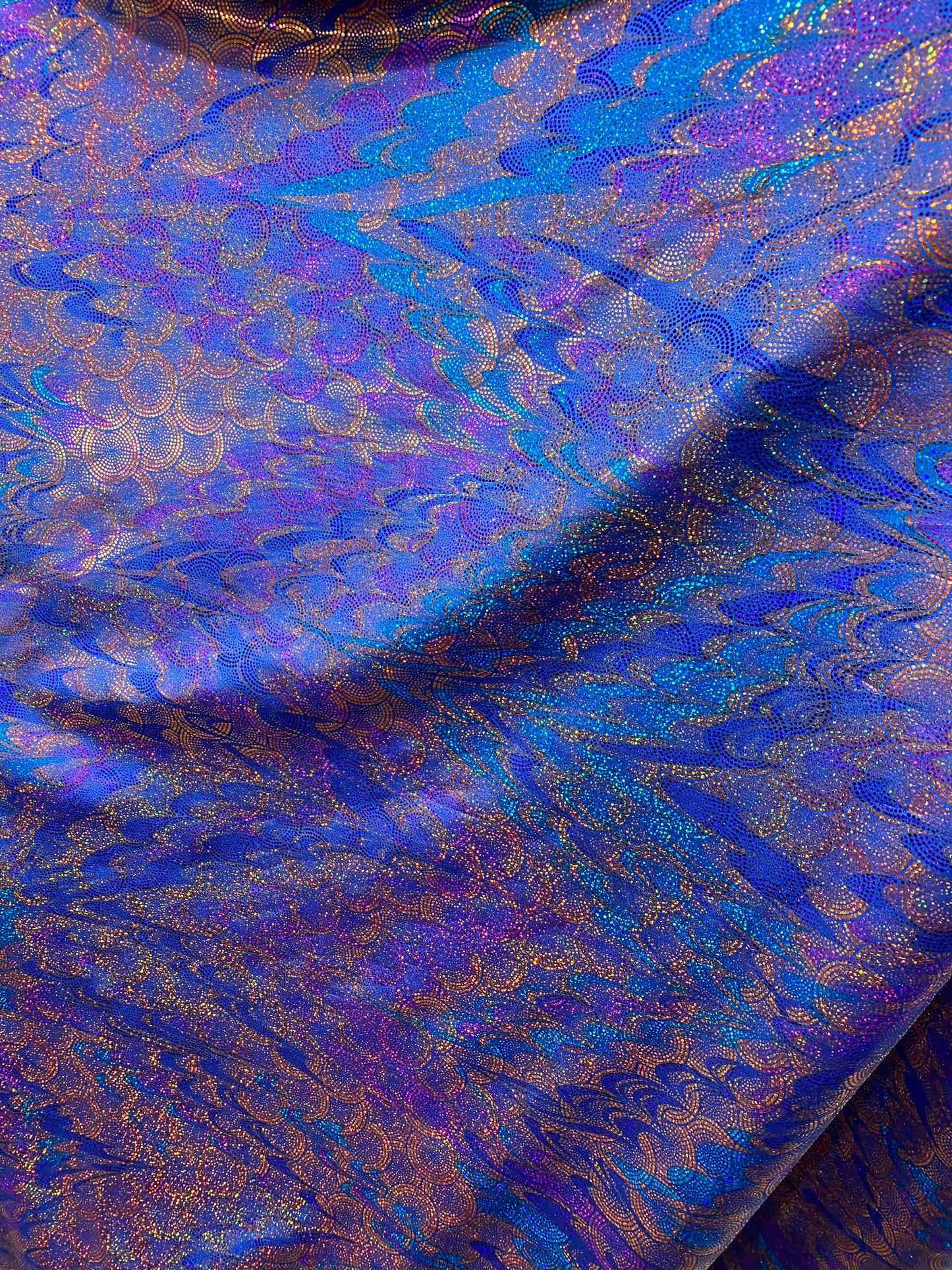 New peacock design hologram sapphire hologram metallic nylon spandex 4-way stretch 58/60” Sold by the YD. Ships worldwide from Los Angeles