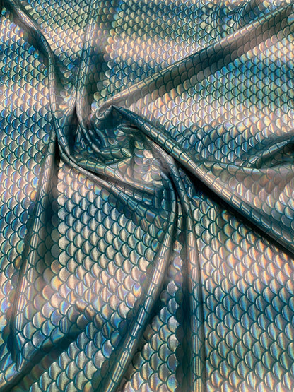 New Rainbow mermaid design Aqua/Teal iridescent metallic nylon spandex 4-way stretch 58/60” Sold by the YD. Ships worldwide from L.A CA.