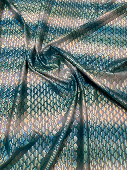 New Rainbow mermaid design Aqua/Teal iridescent metallic nylon spandex 4-way stretch 58/60” Sold by the YD. Ships worldwide from L.A CA.