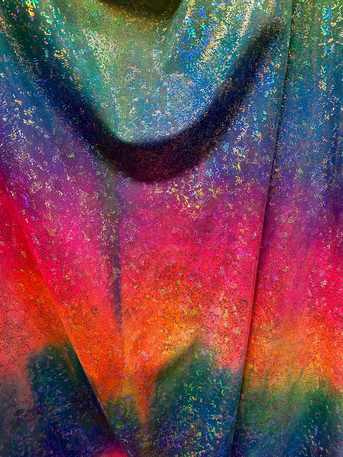 Rainbow tie dye with hologram foil nylon spandex 4-way stretch 58/60” Sold by the YD. Ships worldwide from Los Angeles California USA.