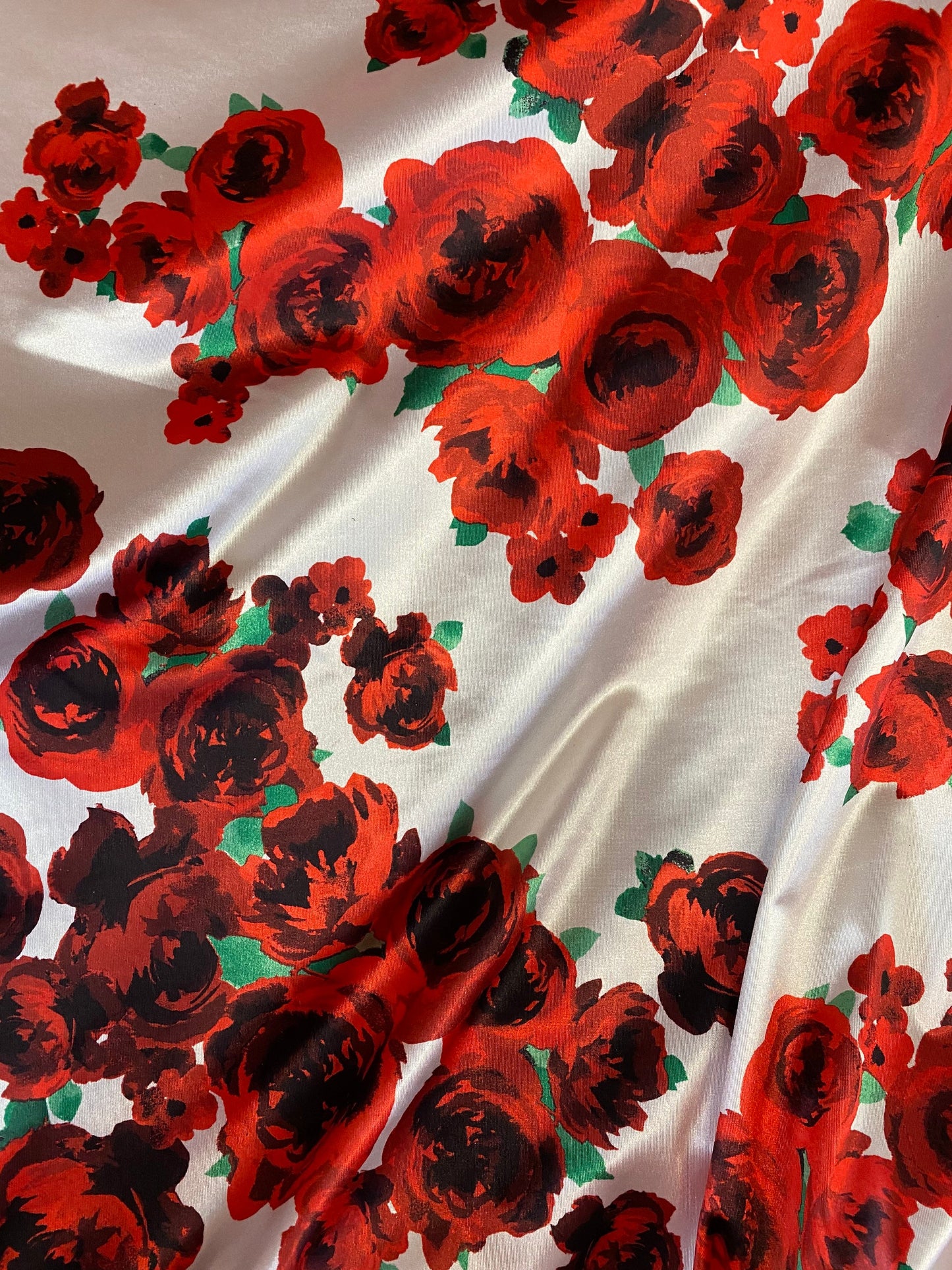 New poly shining spandex with red flower design 4-way stretch 58/60” Sold by the YD. Ships worldwide from Los Angeles California USA.