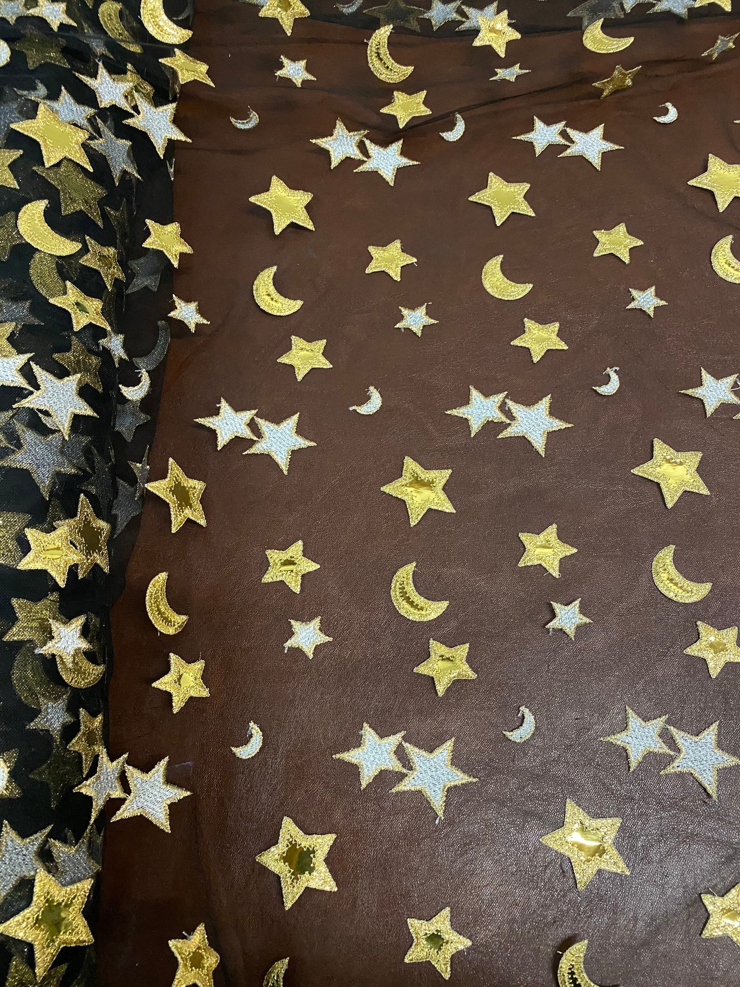 New stars and moons design shining gold vinyl in black poly mesh 2-way stretch 58/60” Sold by the YD. Ships worldwide from Los Angeles CA.