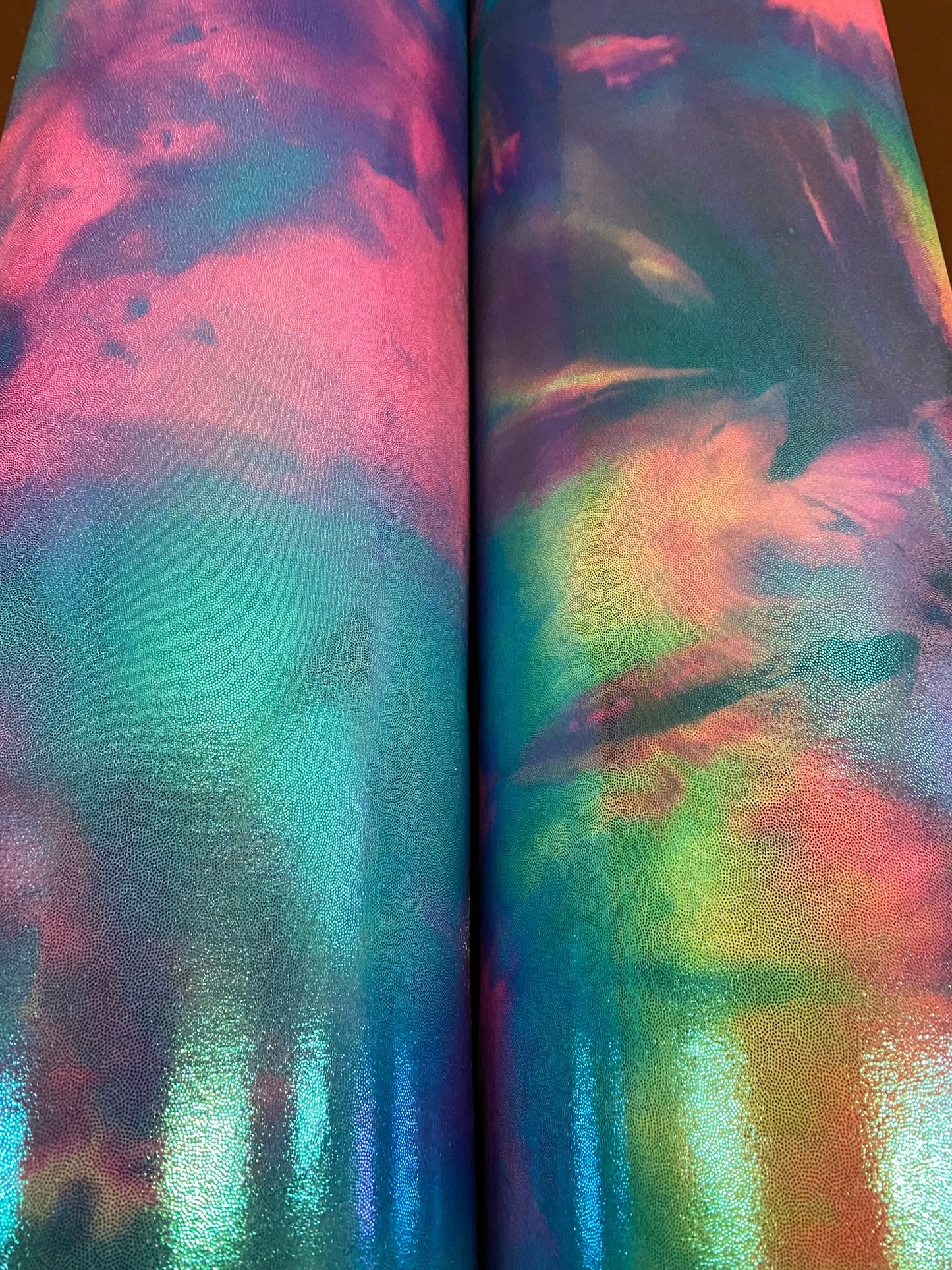 New cotton candy and multi pastel tie dye metallic nylon spandex with foggy foil 4-way stretch 58/60” Sold by the YD.