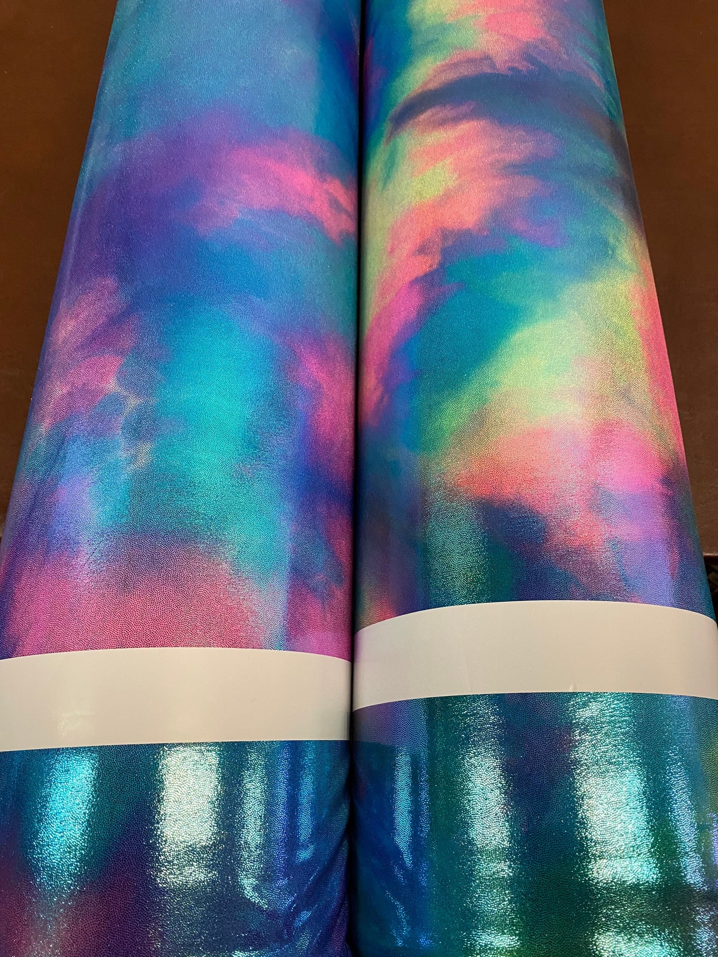 New cotton candy and multi pastel tie dye metallic nylon spandex with foggy foil 4-way stretch 58/60” Sold by the YD.