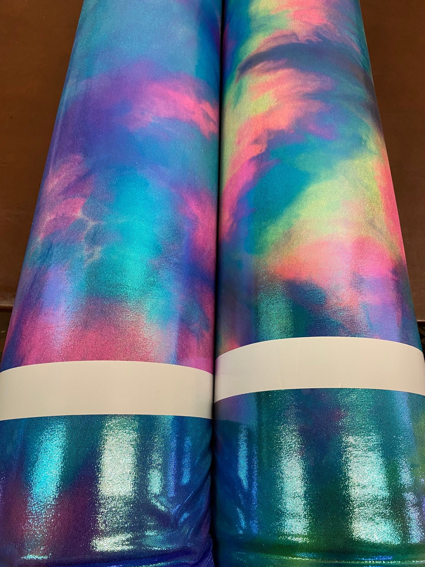 New cotton candy and multi pastel tie dye metallic nylon spandex with foggy foil 4-way stretch 58/60” Sold by the YD.