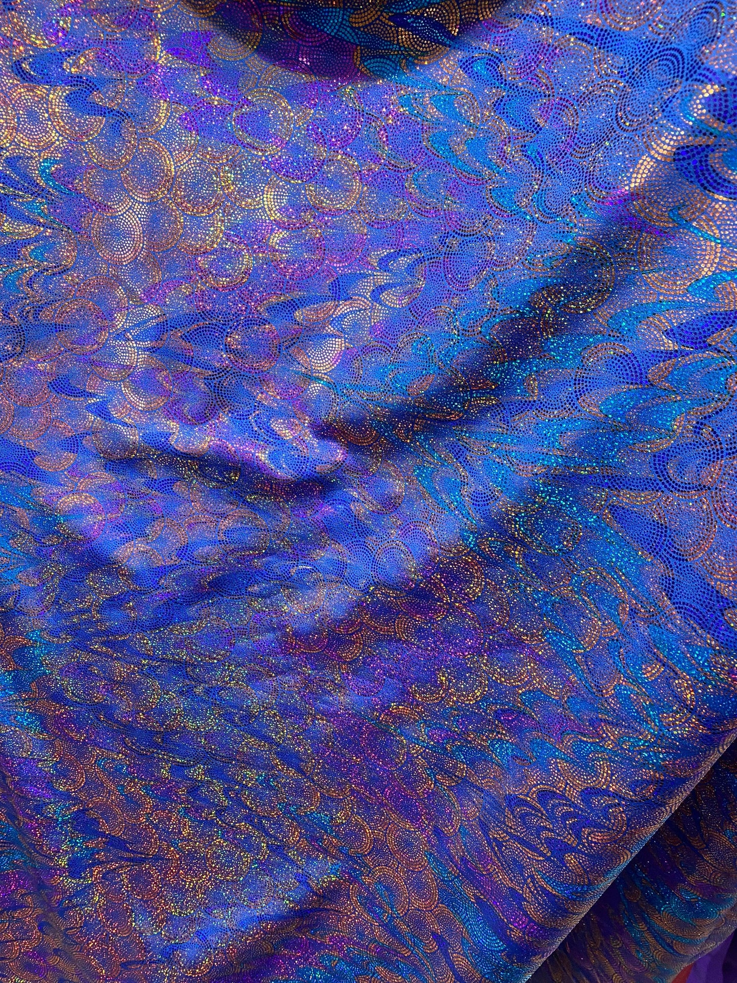 New peacock design hologram sapphire hologram metallic nylon spandex 4-way stretch 58/60” Sold by the YD. Ships worldwide from Los Angeles