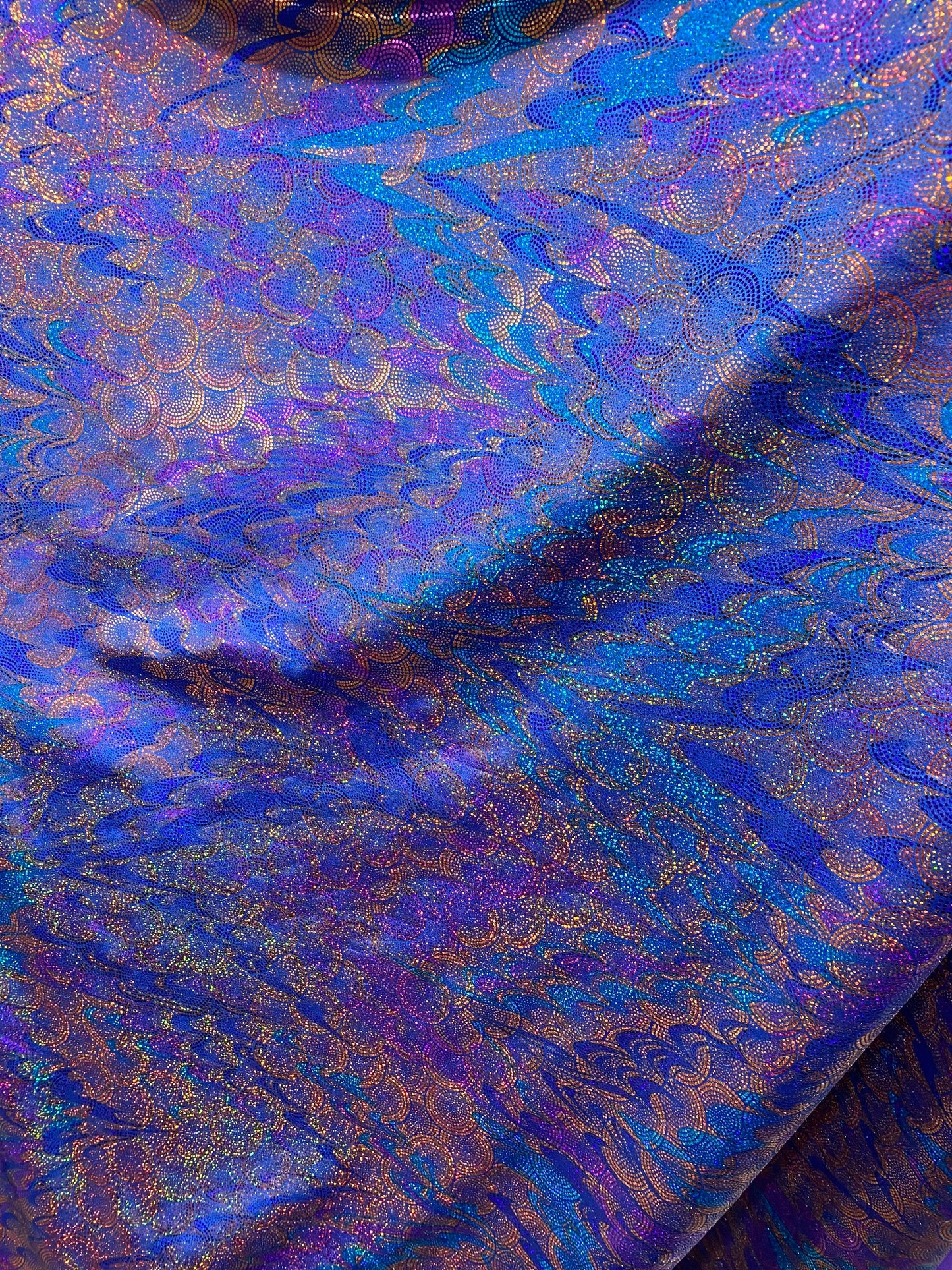 New peacock design hologram sapphire hologram metallic nylon spandex 4-way stretch 58/60” Sold by the YD. Ships worldwide from Los Angeles