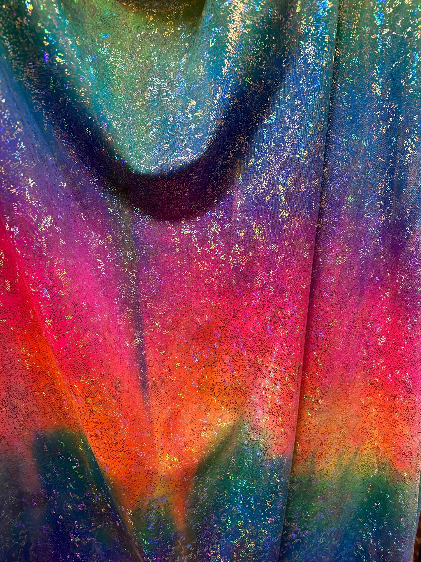 Rainbow tie dye with hologram foil nylon spandex 4-way stretch 58/60” Sold by the YD. Ships worldwide from Los Angeles California USA.