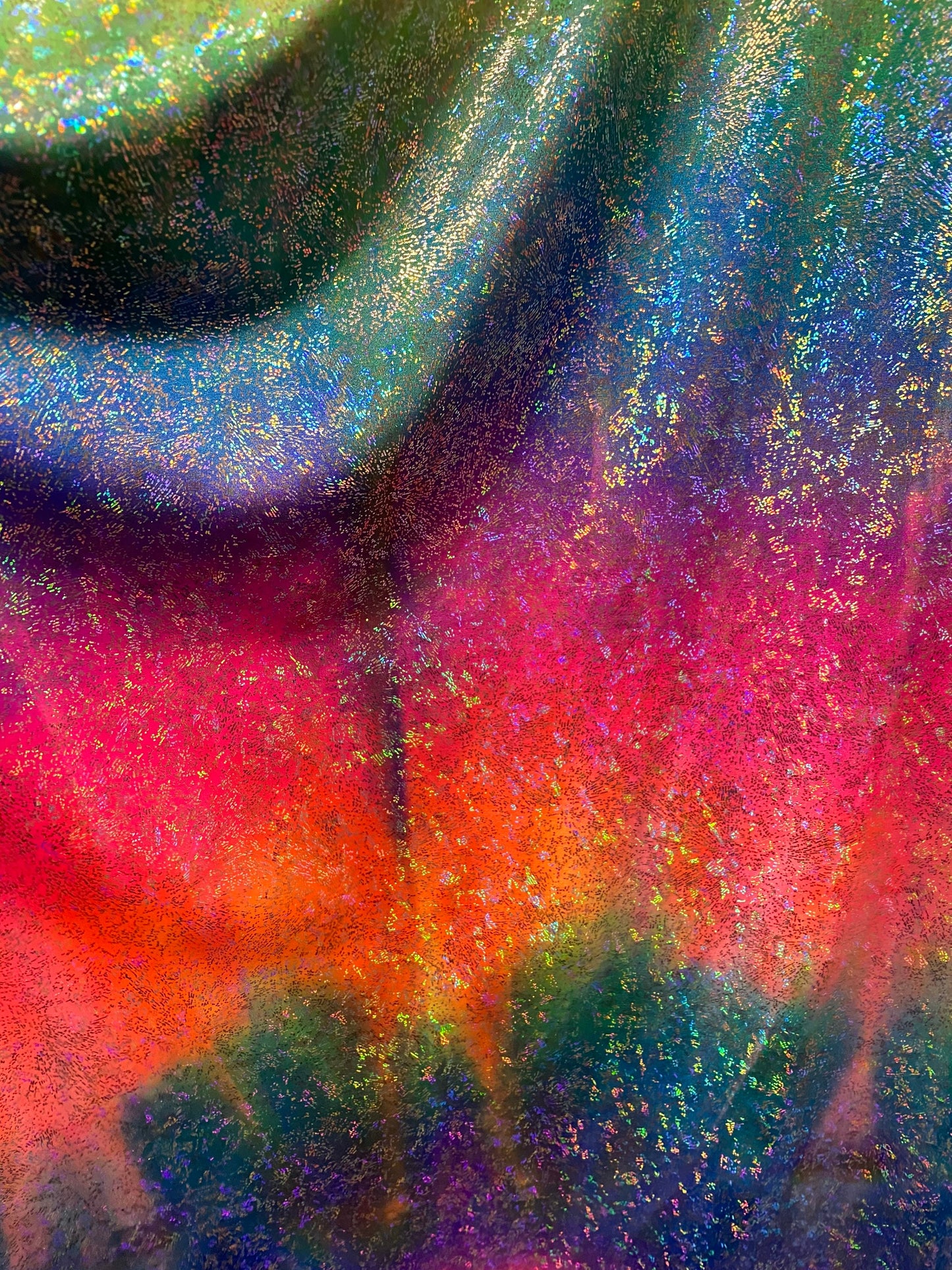 Rainbow tie dye with hologram foil nylon spandex 4-way stretch 58/60” Sold by the YD. Ships worldwide from Los Angeles California USA.