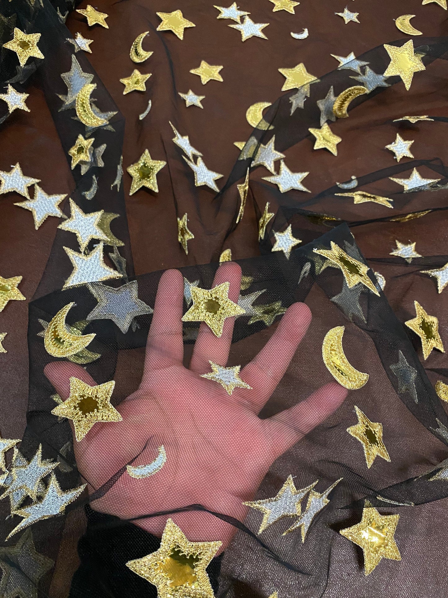 New stars and moons design shining gold vinyl in black poly mesh 2-way stretch 58/60” Sold by the YD. Ships worldwide from Los Angeles CA.