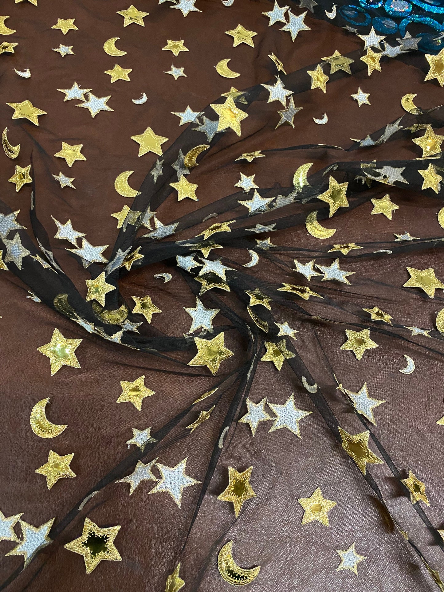 New stars and moons design shining gold vinyl in black poly mesh 2-way stretch 58/60” Sold by the YD. Ships worldwide from Los Angeles CA.