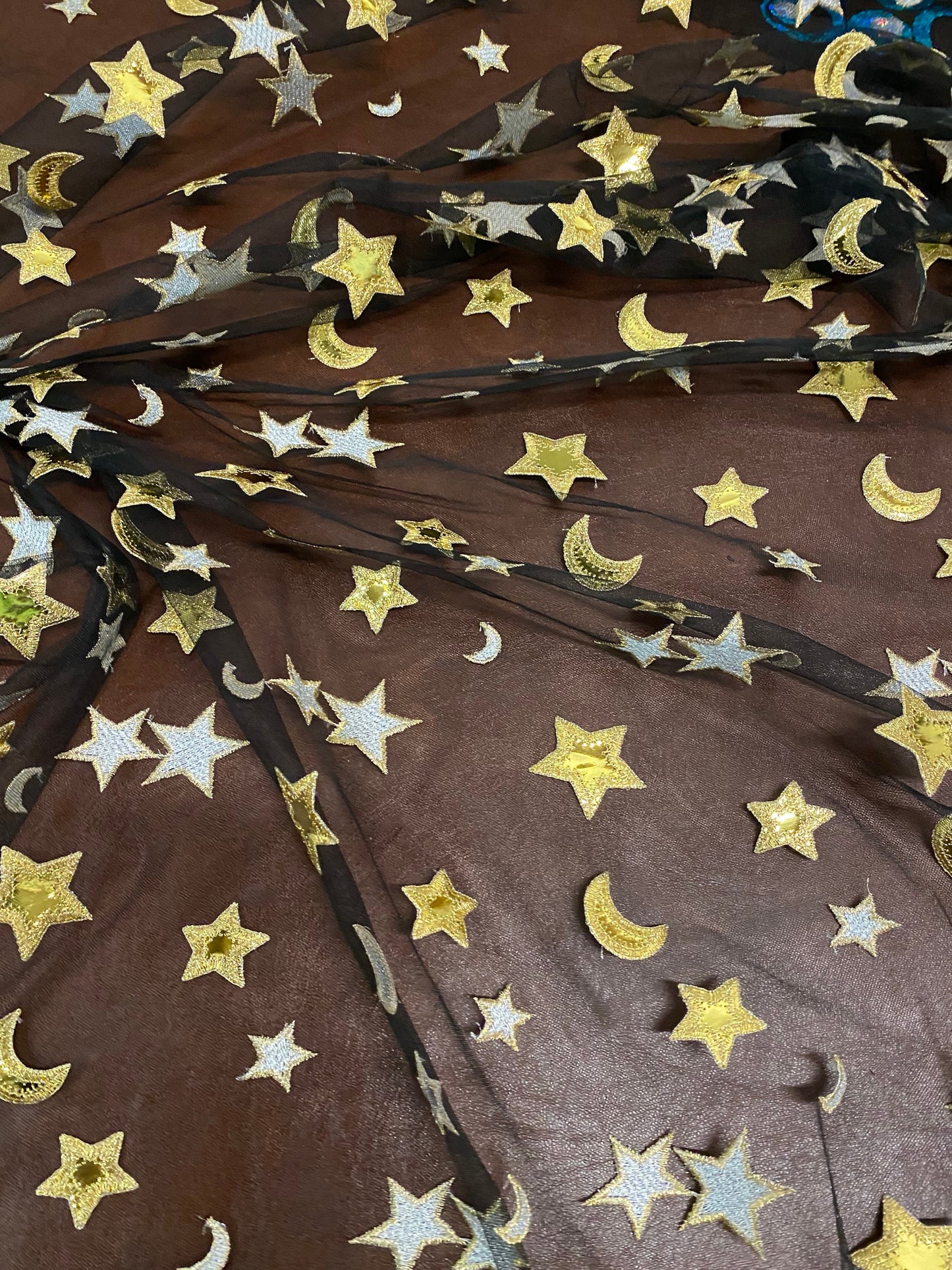 New stars and moons design shining gold vinyl in black poly mesh 2-way stretch 58/60” Sold by the YD. Ships worldwide from Los Angeles CA.