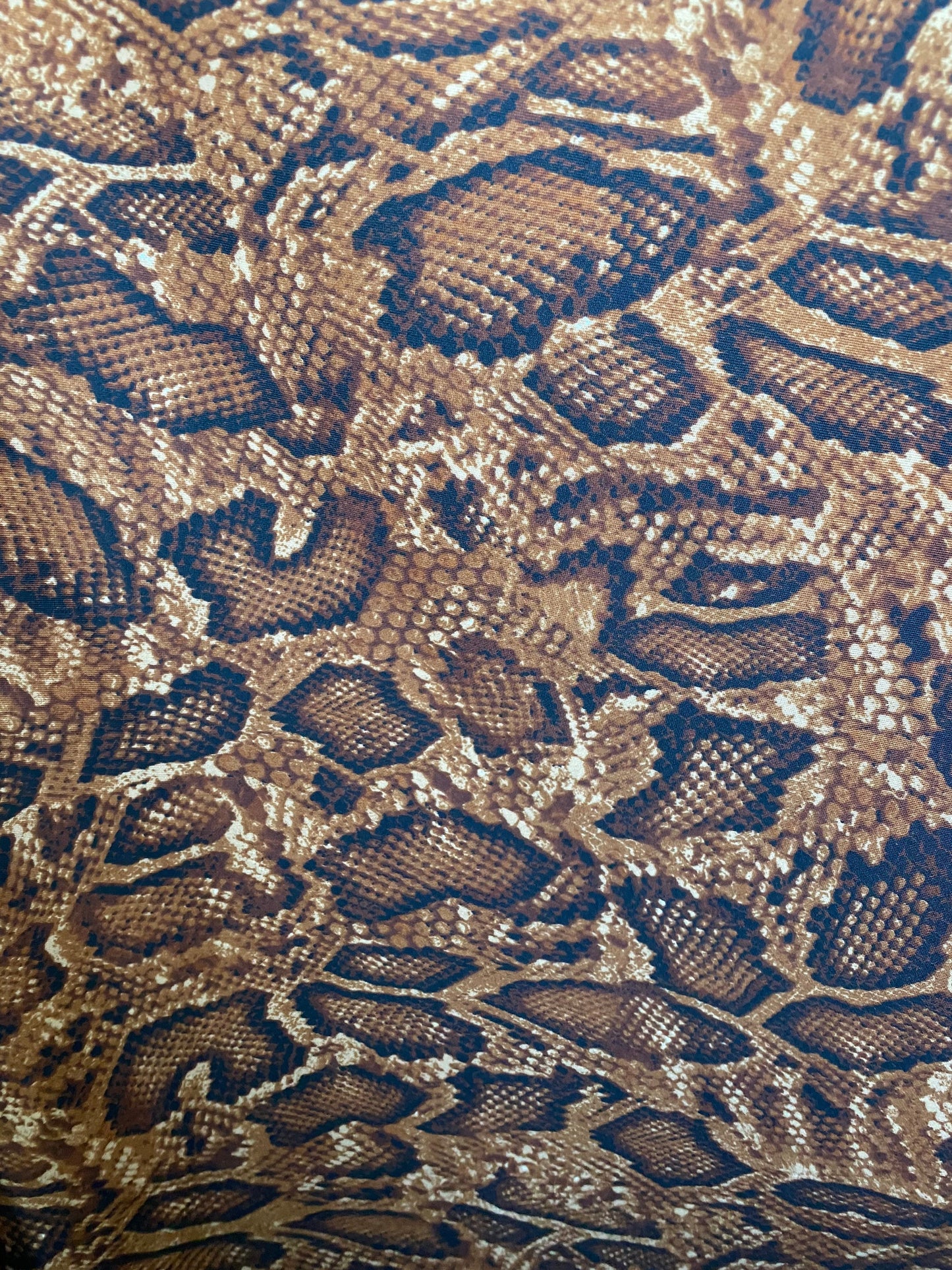 New exotic snake design taupe/sapphire/black print on poly techno 2-way stretch medium weight 58/60” Sold by the YD. Ships worldwide