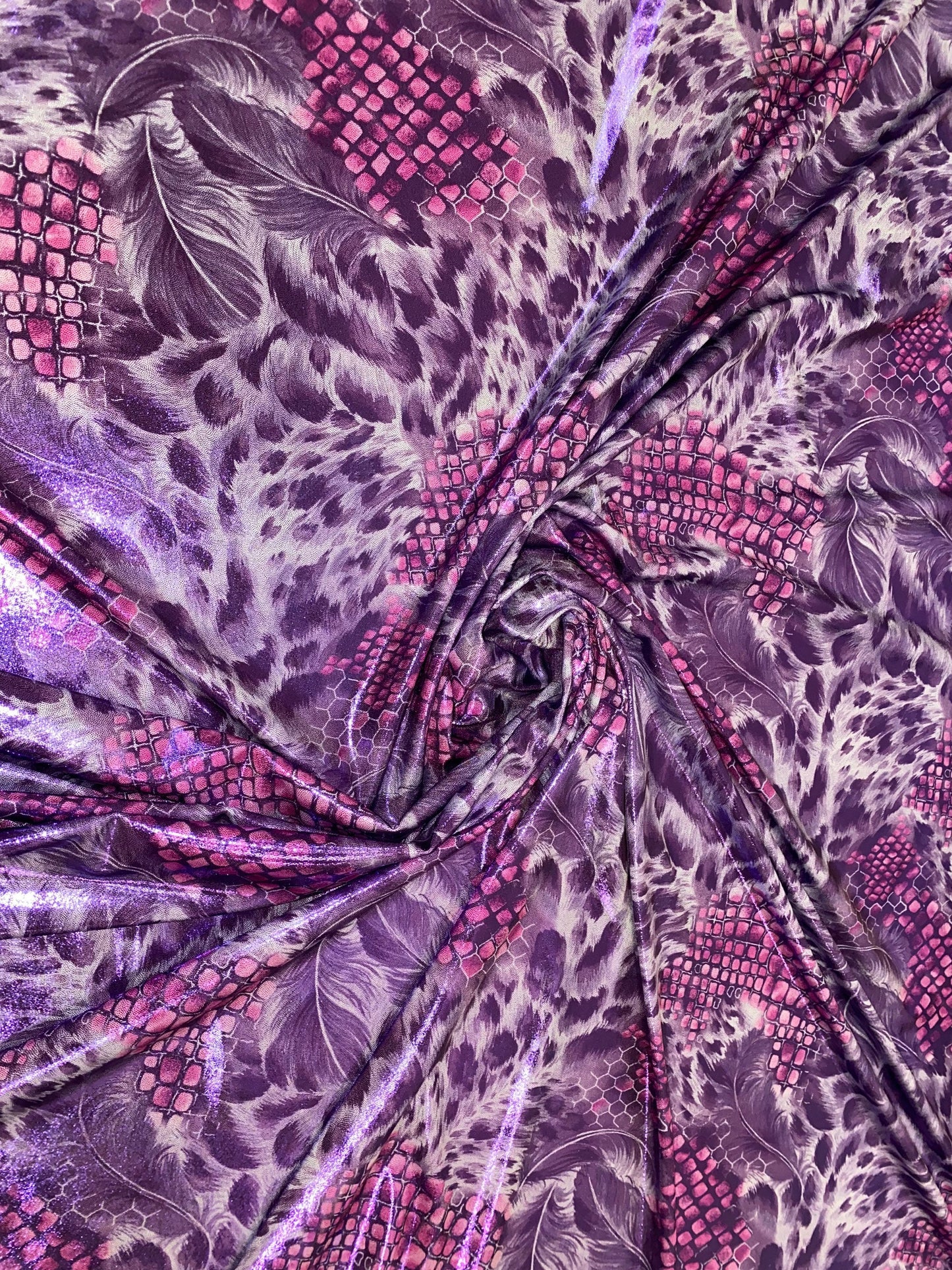 New safari feathers design print on nylon spandex with foggy foil all over metallic nylon spandex 4-way stretch 58/60” Sold by the YD.