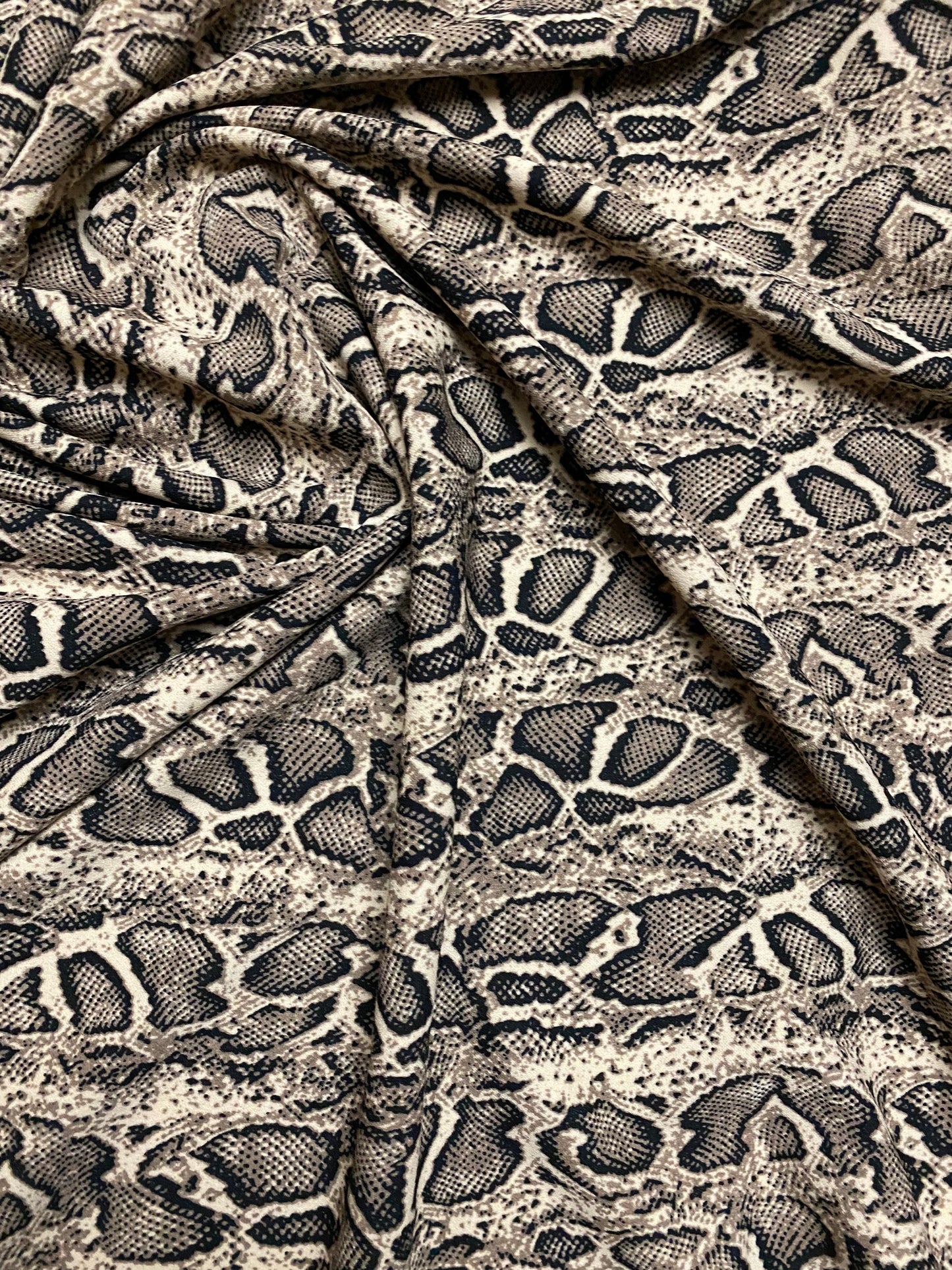 New Exotic snake design taupe/black print on great poly spandex 2-way stretch 58/60” Sold by the YD. Ships worldwide from Los Angeles CA.