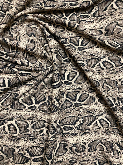 New Exotic snake design taupe/black print on great poly spandex 2-way stretch 58/60” Sold by the YD. Ships worldwide from Los Angeles CA.