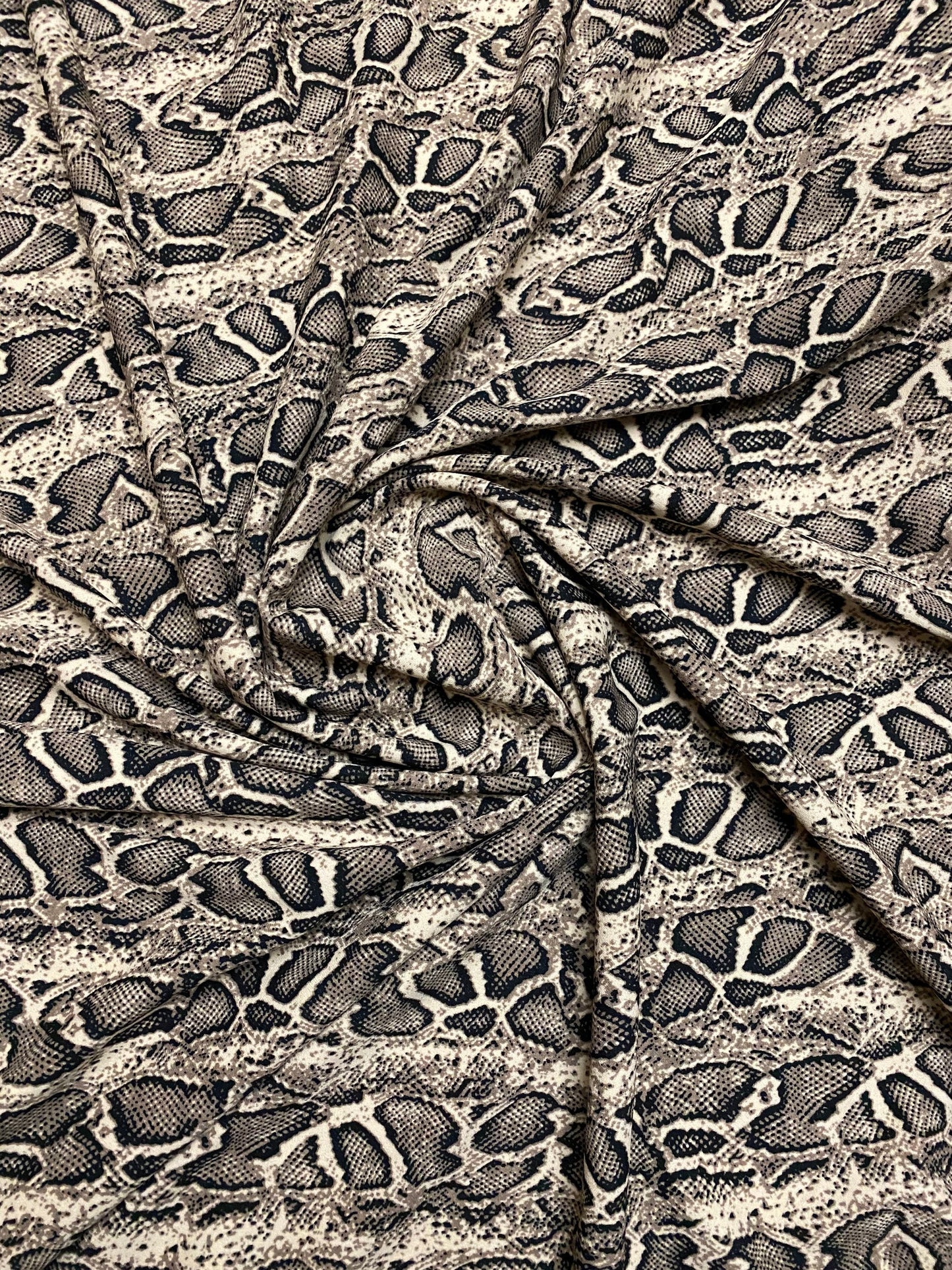 New Exotic snake design taupe/black print on great poly spandex 2-way stretch 58/60” Sold by the YD. Ships worldwide from Los Angeles CA.