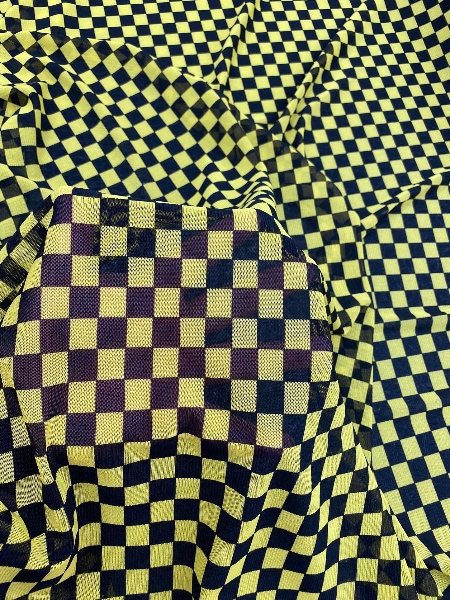 New small Checkered design yellow/black print on power mesh 4-way stretch 58/60” Sold by the YD. Ships worldwide from Los Angeles California