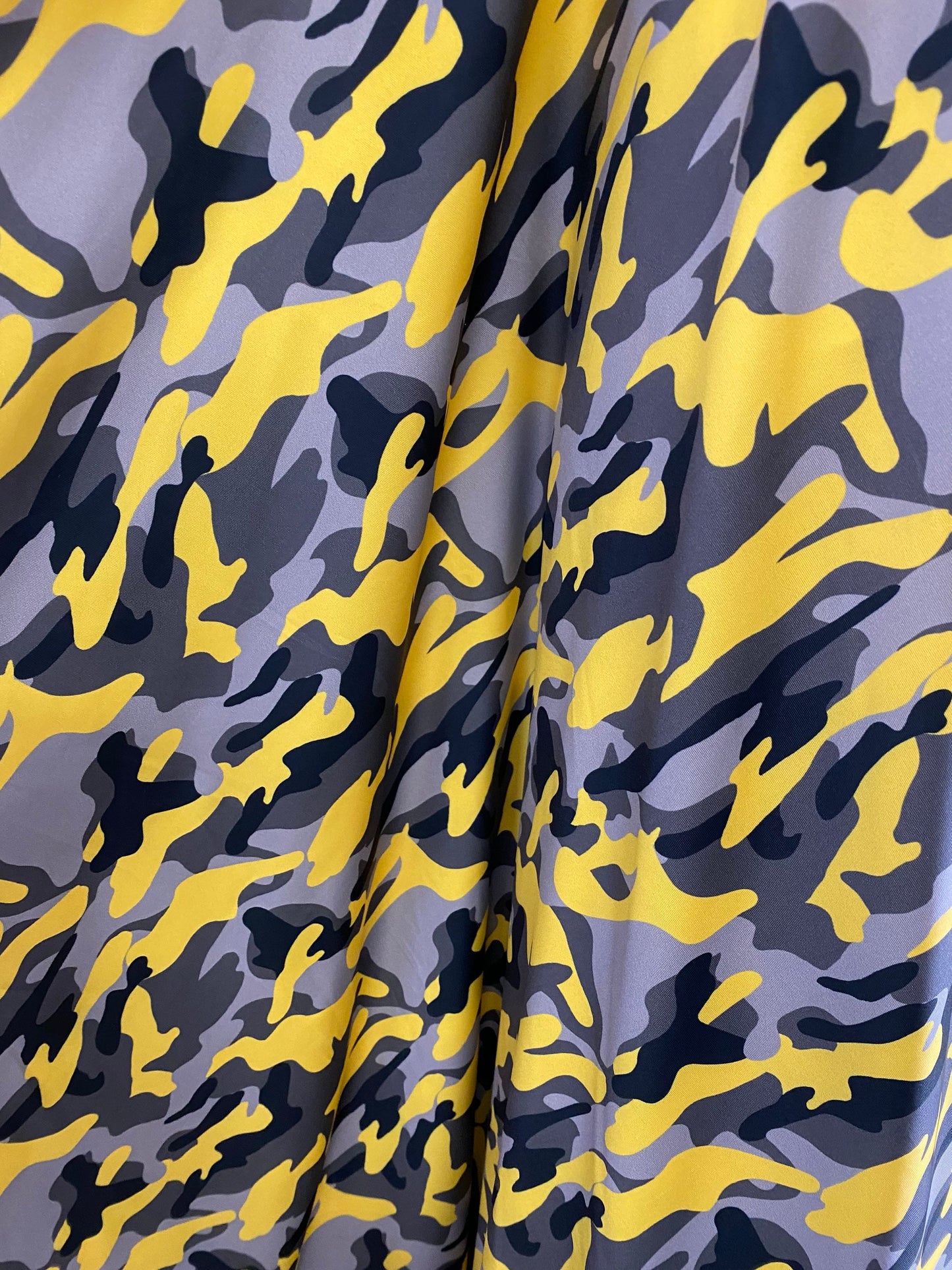 New modern camouflage yellow/black/gray print on great quality of nylon spandex 4-way stretch 58/60” Sold by the YD.