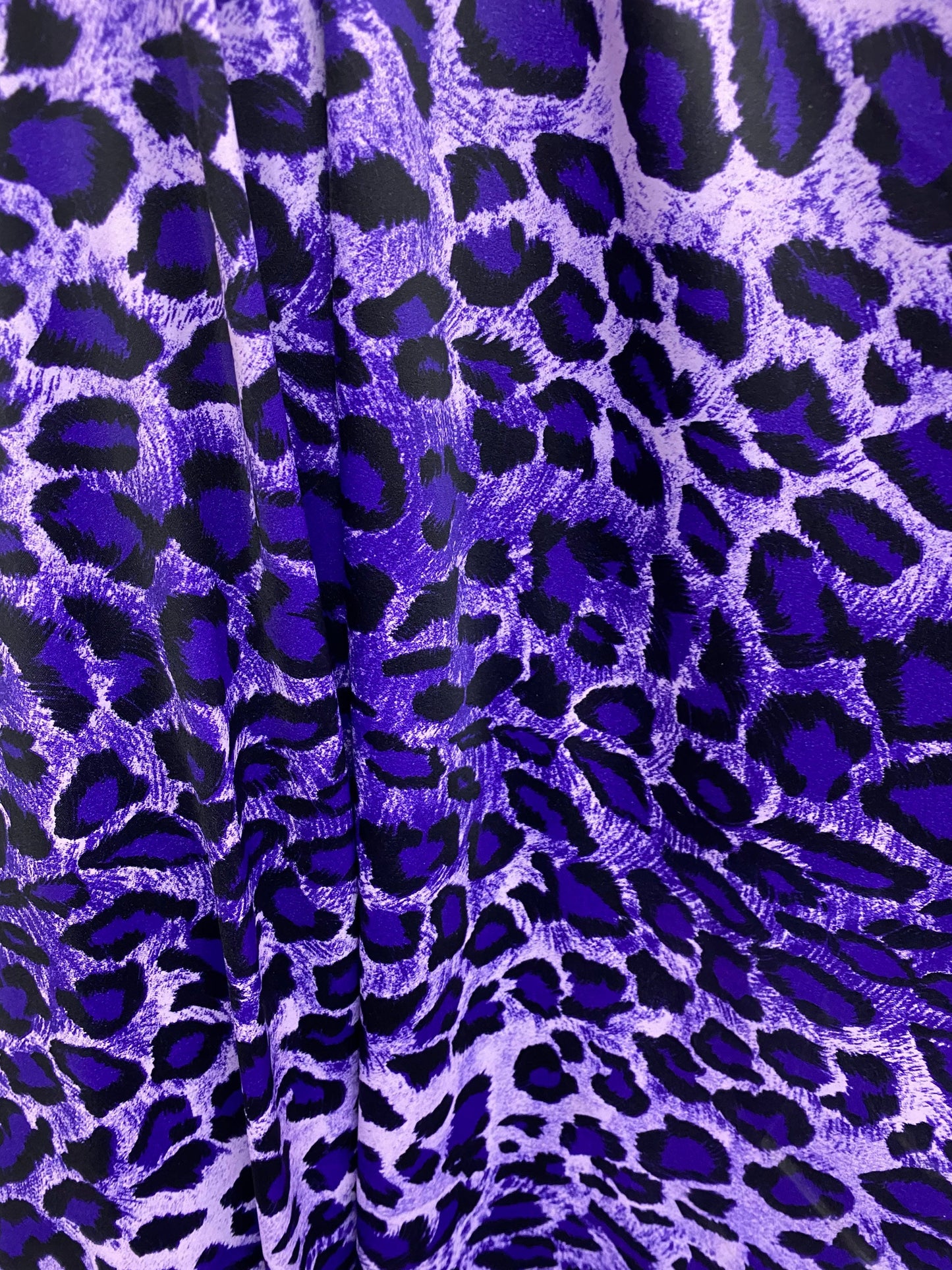 Exotic leopard design purple/black print on nylon spandex 4-way stretch 58/60” Sold by the YD. Ships worldwide from Los Angeles California