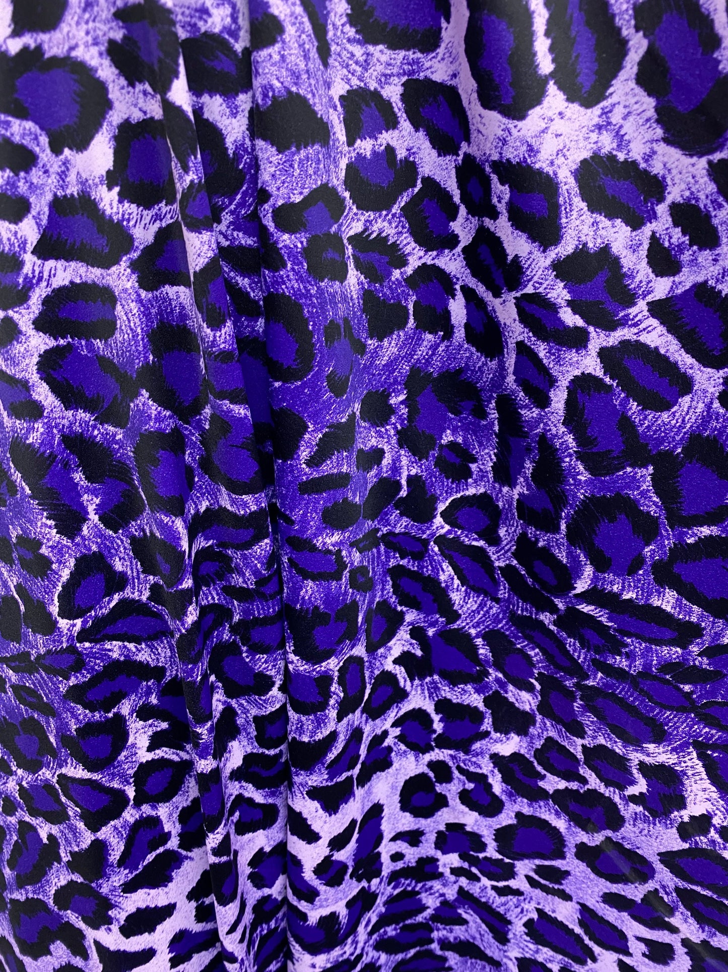 Exotic leopard design purple/black print on nylon spandex 4-way stretch 58/60” Sold by the YD. Ships worldwide from Los Angeles California