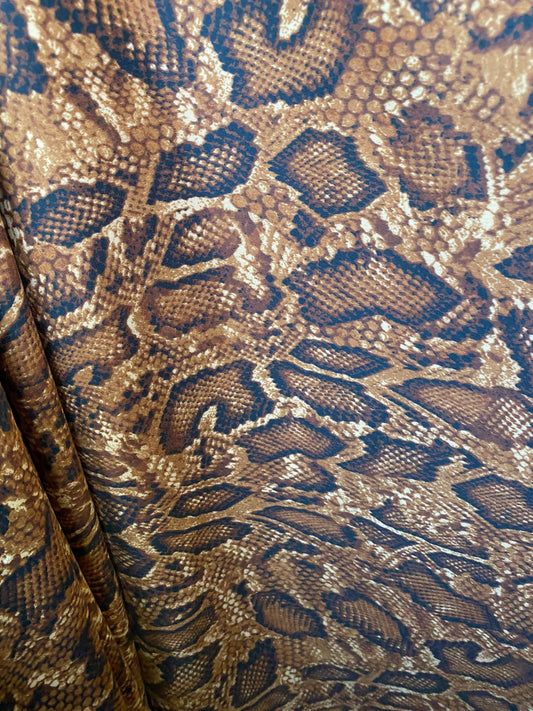 New exotic snake design taupe/sapphire/black print on poly techno 2-way stretch medium weight 58/60” Sold by the YD. Ships worldwide