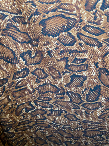 New exotic snake design taupe/sapphire/black print on poly techno 2-way stretch medium weight 58/60” Sold by the YD. Ships worldwide