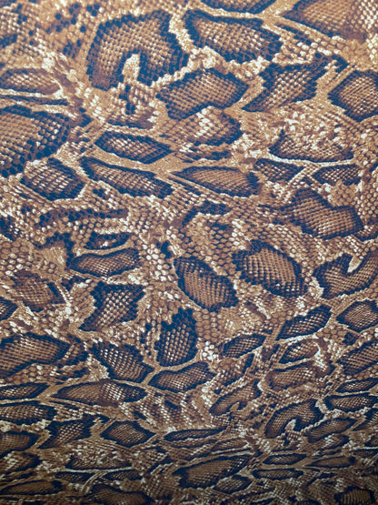 New exotic snake design taupe/sapphire/black print on poly techno 2-way stretch medium weight 58/60” Sold by the YD. Ships worldwide