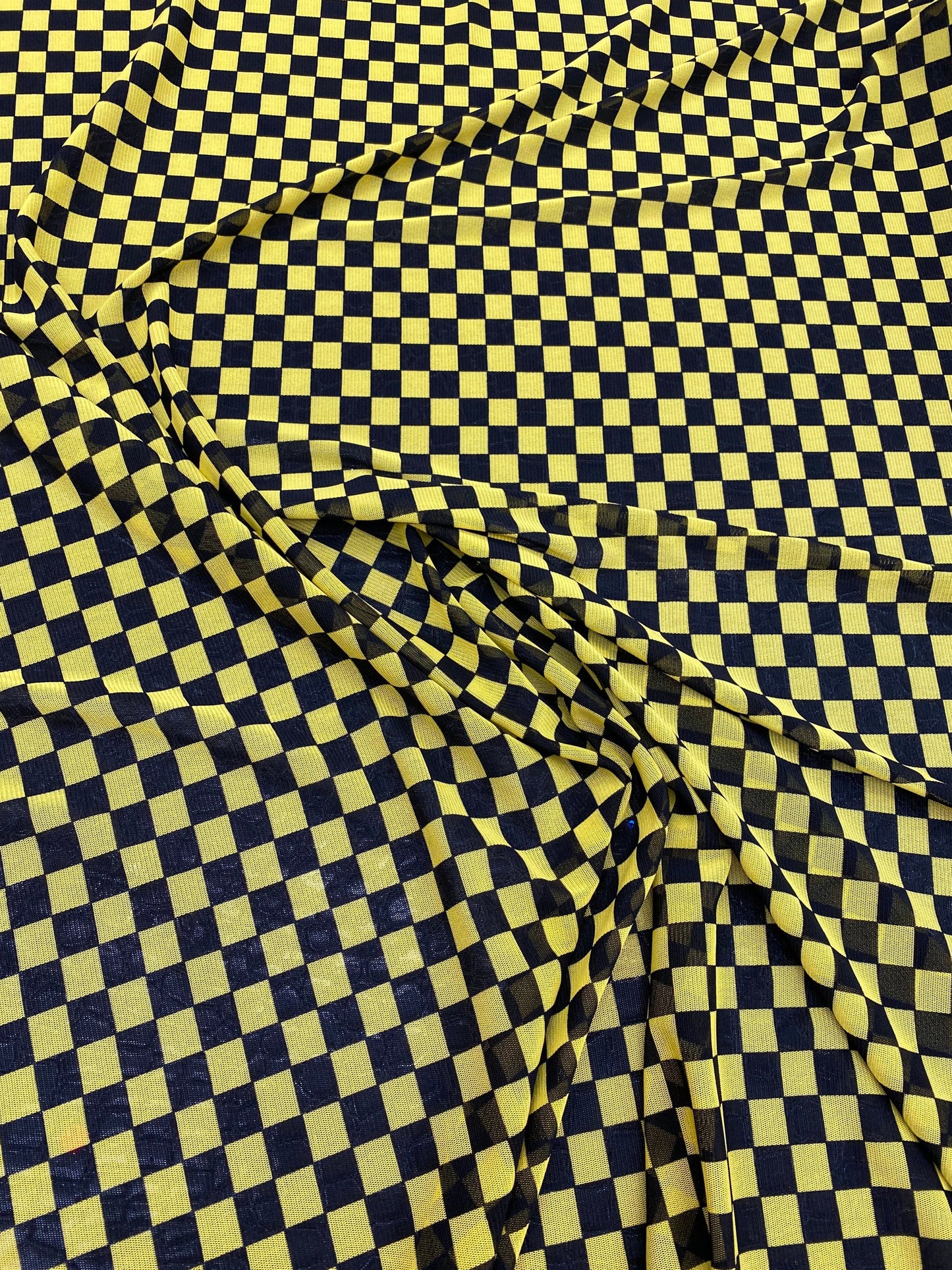 New small Checkered design yellow/black print on power mesh 4-way stretch 58/60” Sold by the YD. Ships worldwide from Los Angeles California