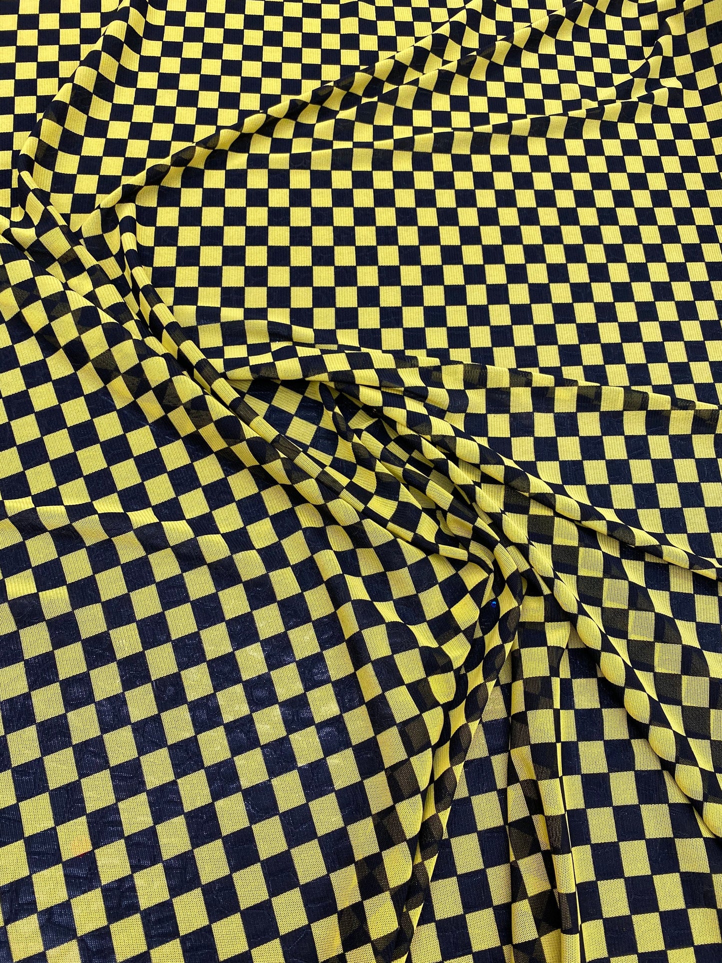 New small Checkered design yellow/black print on power mesh 4-way stretch 58/60” Sold by the YD. Ships worldwide from Los Angeles California