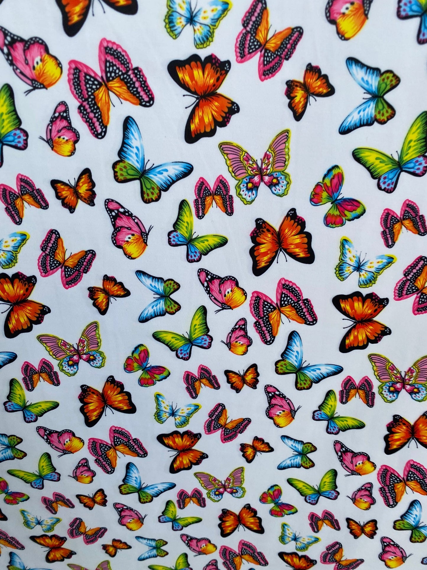 Butterfly design white/rainbow multicolor print on great quality of nylon spandex 4-way stretch 58/)0” Sold by the YD. Ships Worldwide