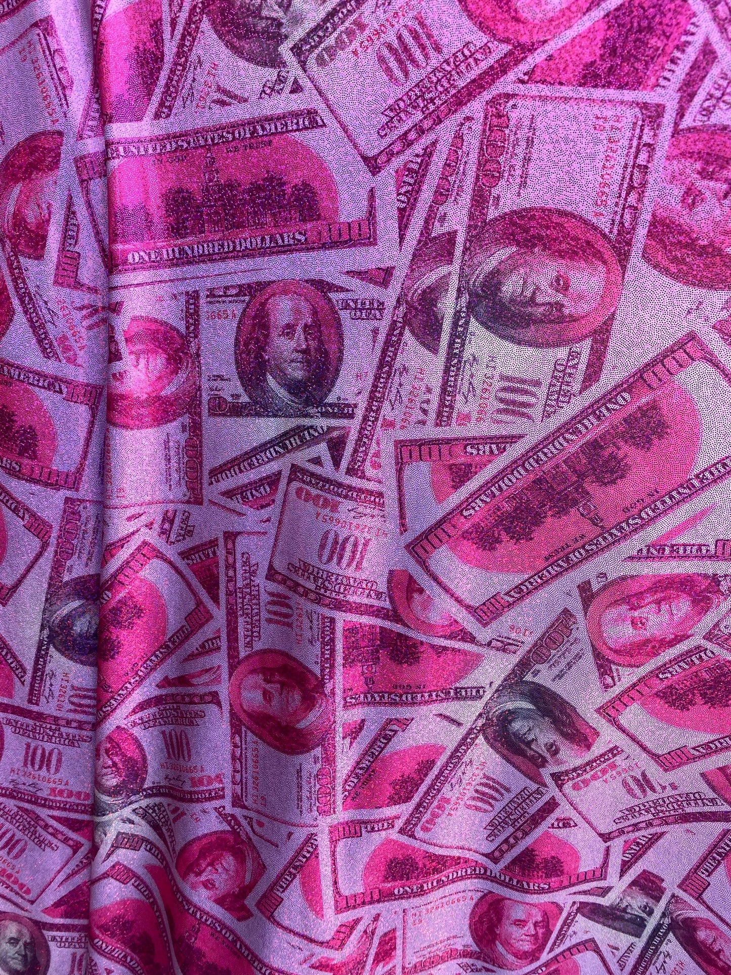 New metallic nylon spandex money design 100 dollar bill pink/green print on 4-way spandex with foggy foil all over 58/60” Sold by the YD.