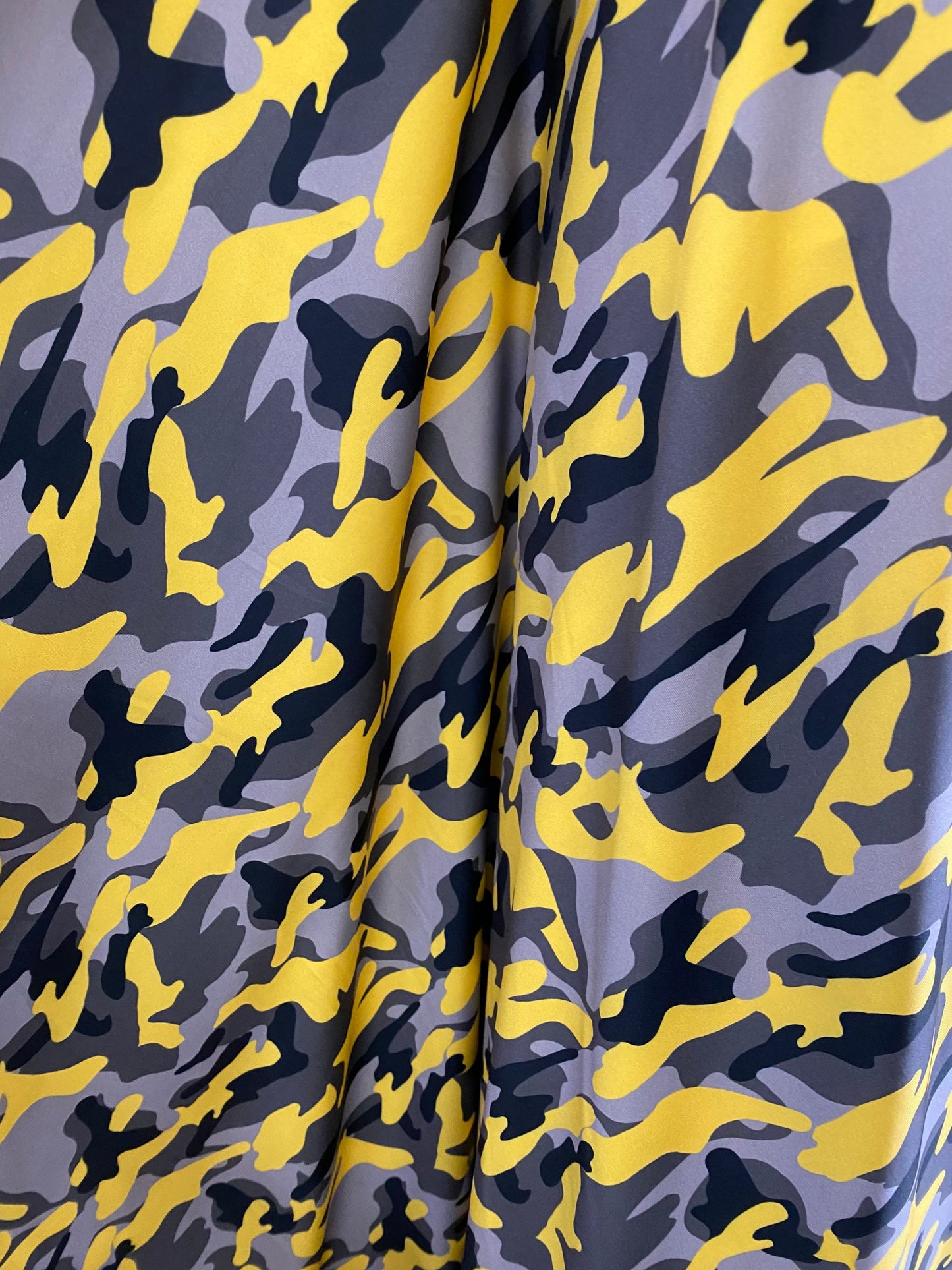 New modern camouflage yellow/black/gray print on great quality of nylon spandex 4-way stretch 58/60” Sold by the YD.