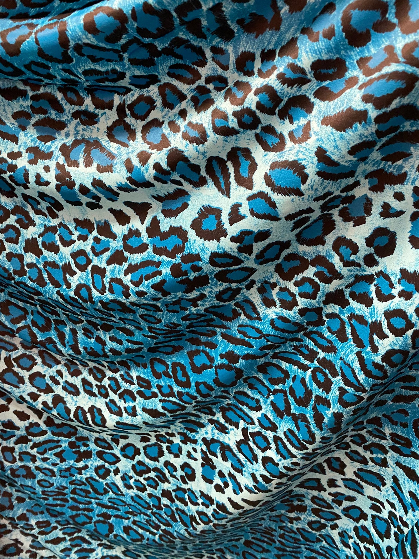 Exotic leopard design Teal/Blue/black print on nylon spandex 4-way stretch 58/60” Sold by the YD. Ships worldwide from Los Angeles Californi