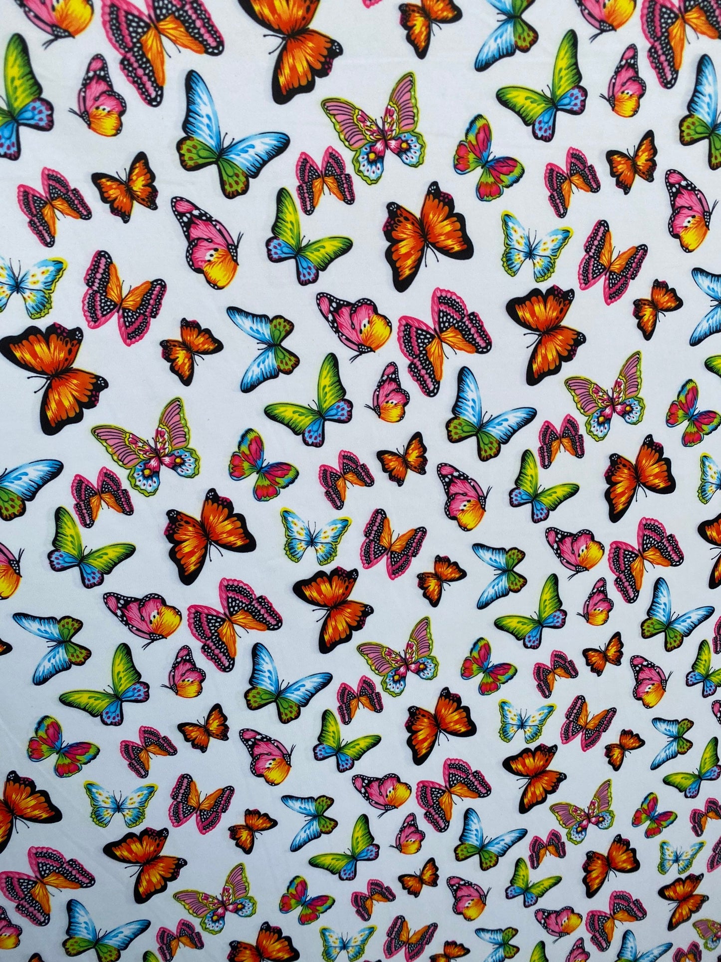 Butterfly design white/rainbow multicolor print on great quality of nylon spandex 4-way stretch 58/)0” Sold by the YD. Ships Worldwide