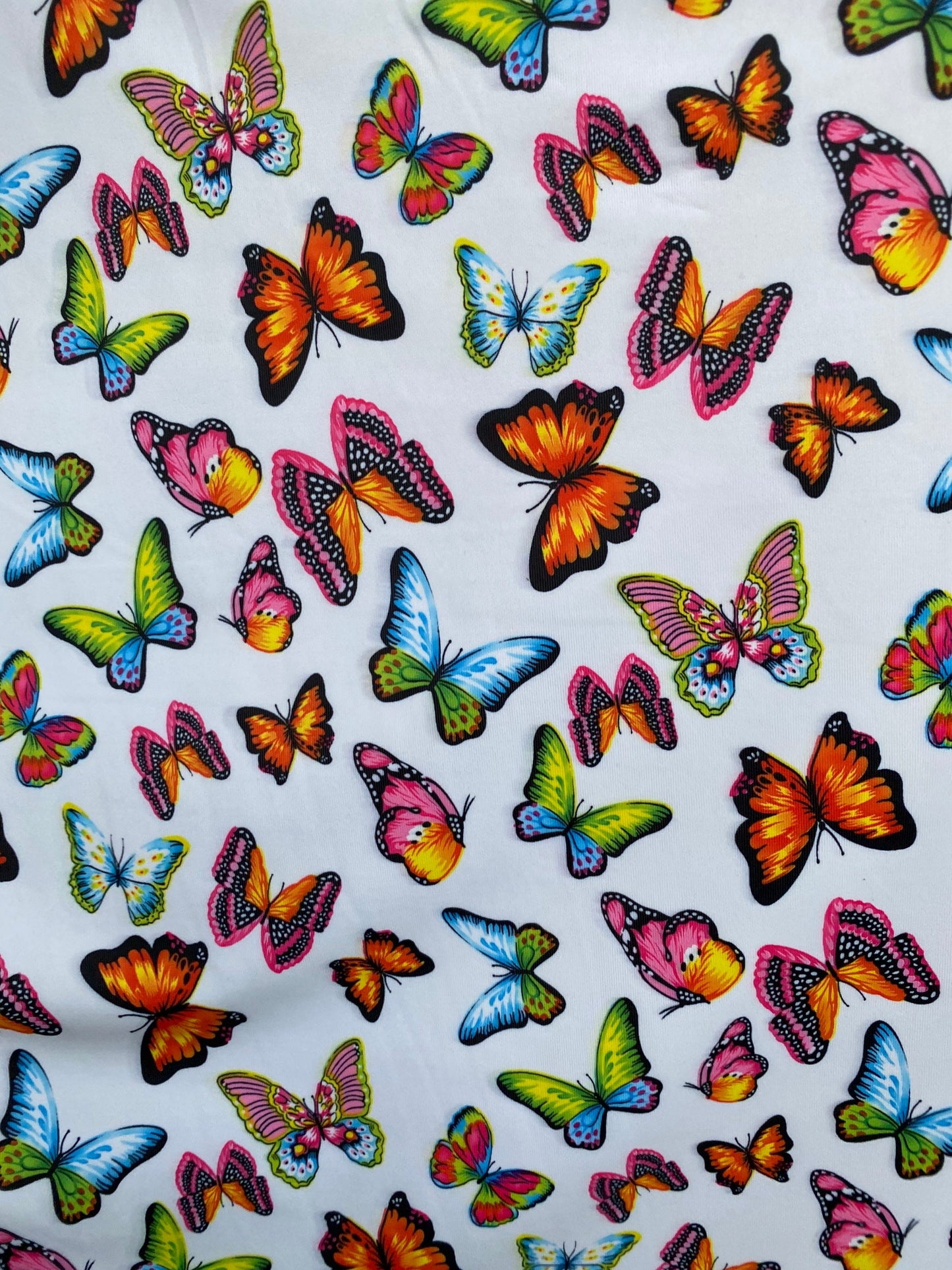 Butterfly design white/rainbow multicolor print on great quality of nylon spandex 4-way stretch 58/)0” Sold by the YD. Ships Worldwide