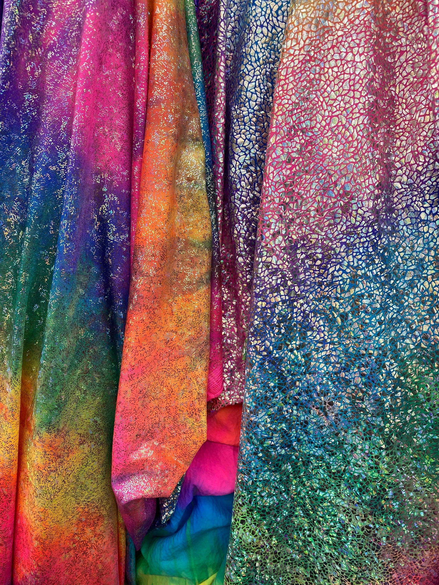 New Rainbow hologram metallic nylon spandex 4-way stretch rainbow fireworks and rainbow reptile snake hologram foil 58/60” Sold by the YD.