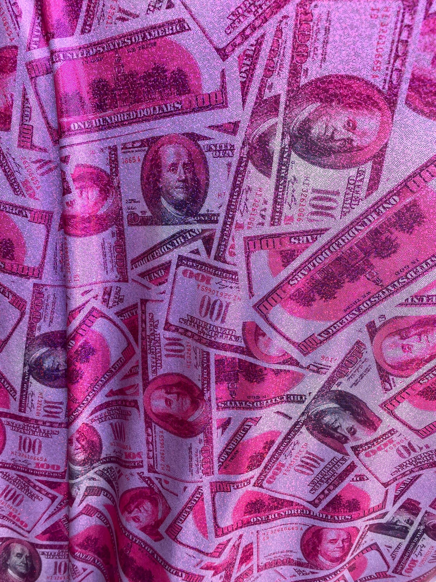 New metallic nylon spandex money design 100 dollar bill pink/green print on 4-way spandex with foggy foil all over 58/60” Sold by the YD.