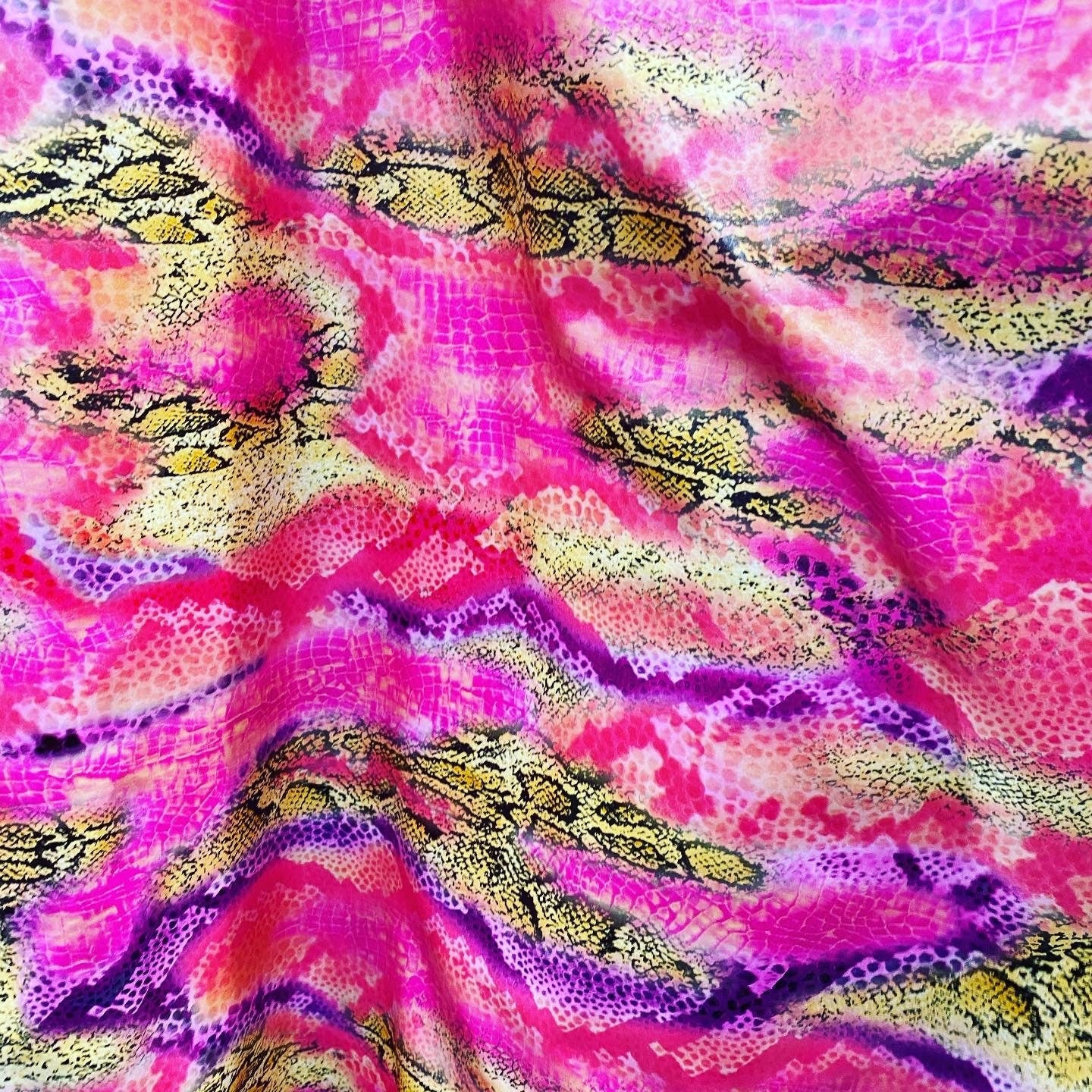 New Exotic snake design pink multicolor print on poly spandex multicolor with all over foil 2-way stretch 58/60” Sold by the YD.