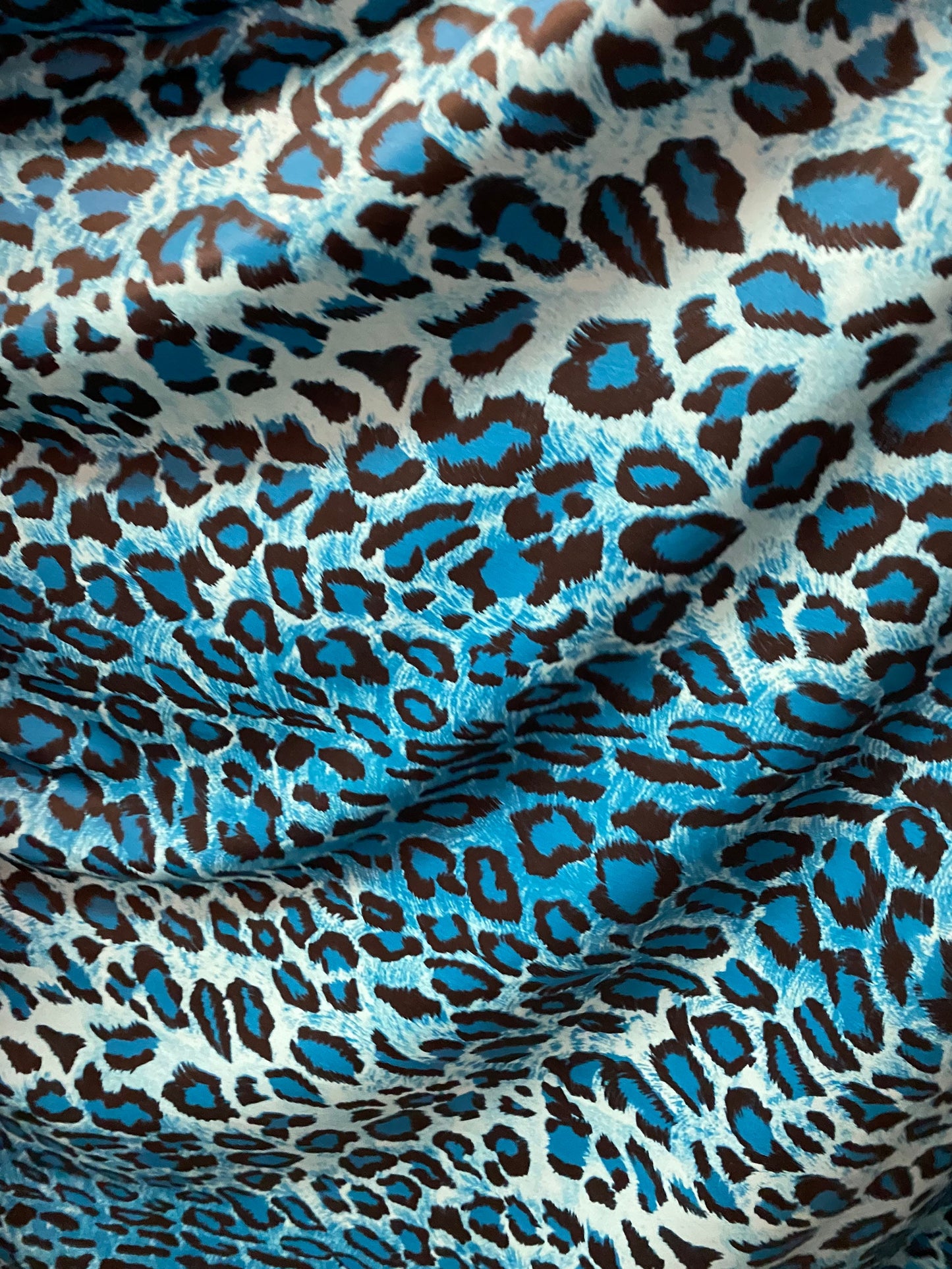 Exotic leopard design Teal/Blue/black print on nylon spandex 4-way stretch 58/60” Sold by the YD. Ships worldwide from Los Angeles Californi